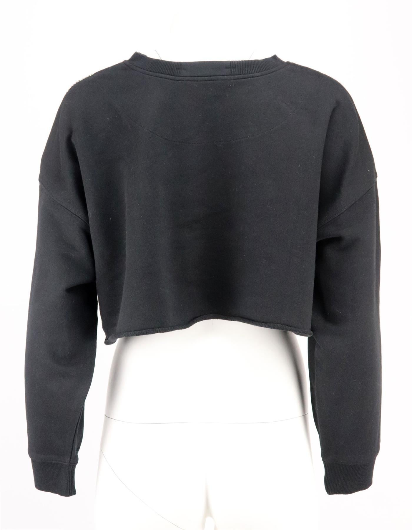 This sweatshirt by Christopher Kane fits for a cropped silhouette and comes in a black hue that can be seen throughout the brands collections, it's made from cotton with crystal embellishment down both sleeves. Black cotton. Slips on. 100% Cotton.