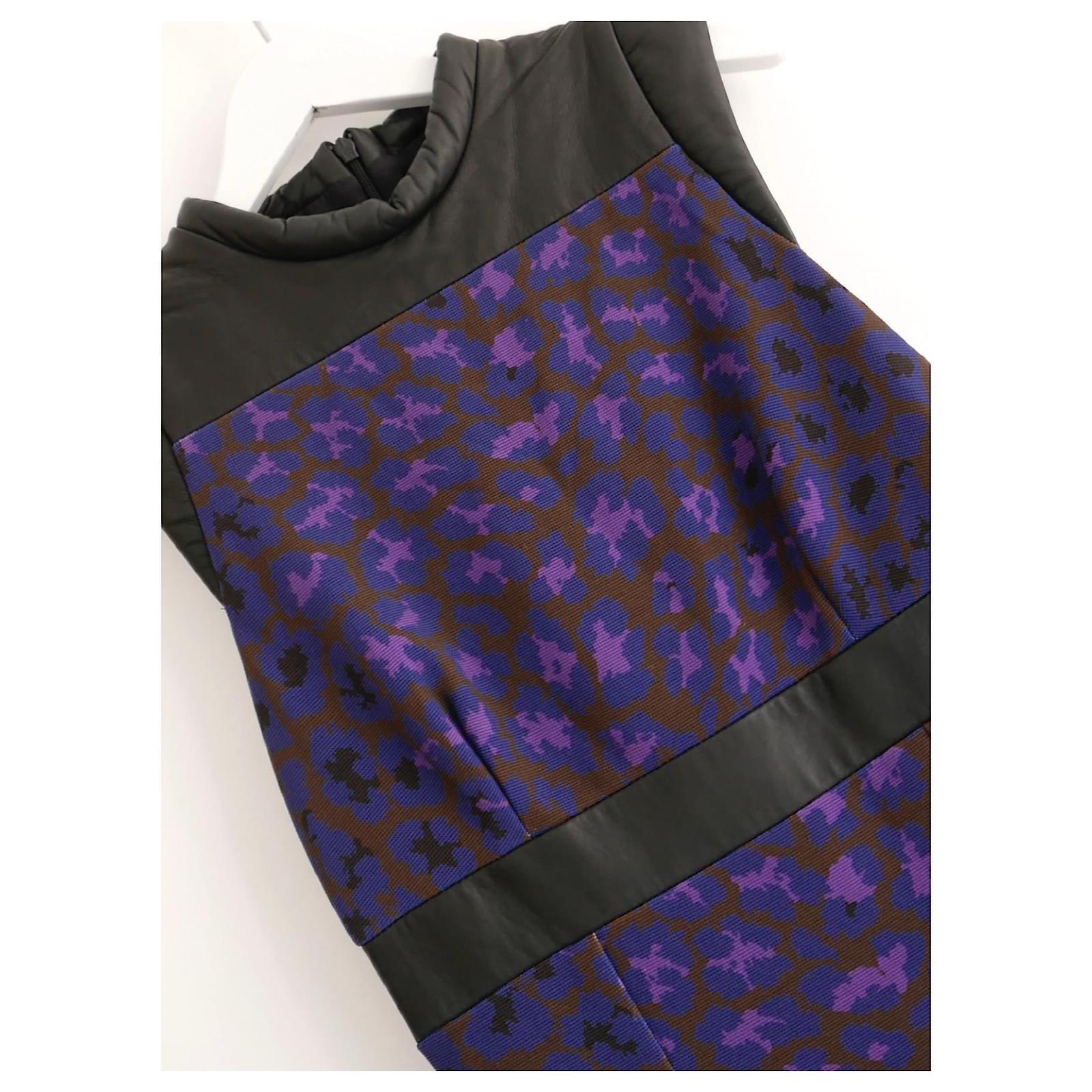 Super cool leopard brocade and quilted leather dress from Christopher Kane's Fall 2012 collection. Bought for £900 and unworn. Made from purple and blue textured thick polyester twill with soft leather puffer trims, it side slit pockets, raises