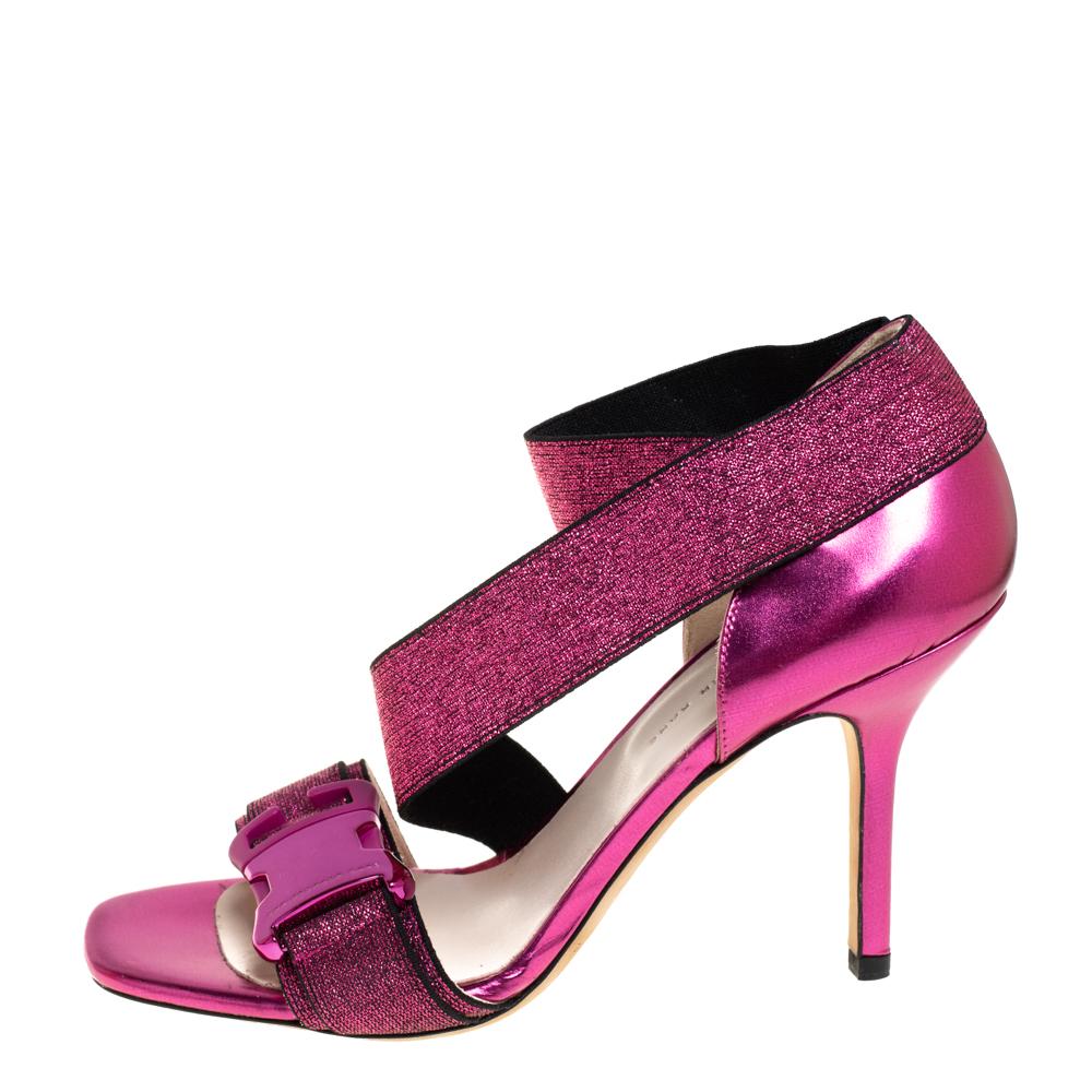 Go bold and glamorous in these stunning sandals from Christopher Kane! Crafted from pink glitter and leather, they feature a strappy silhouette with open toes. They flaunt buckle detailed vamp straps, elastic ankle straps, and comfortable