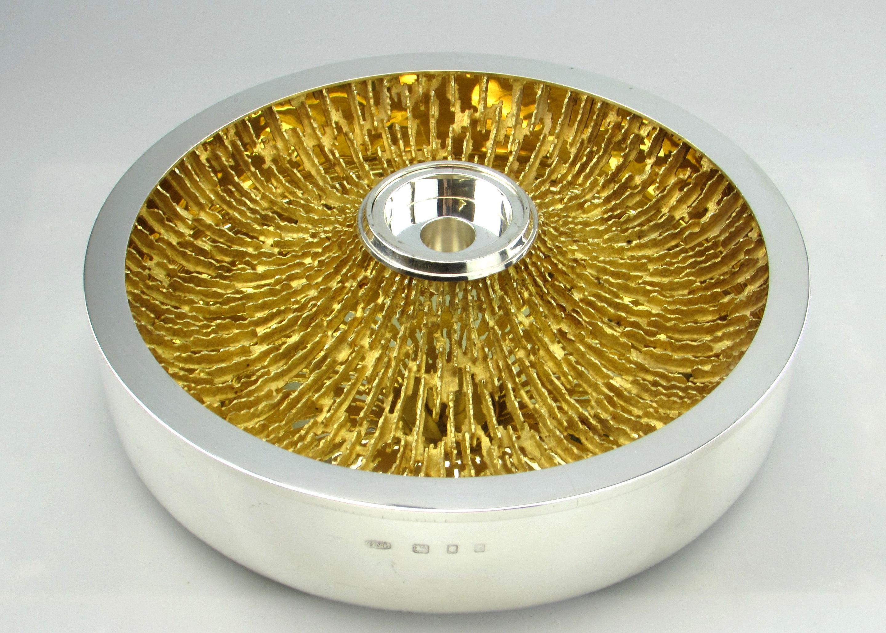 A spectacular large Modernist Solid Silver & Silver Gilt Centre Piece or Bowl with an adaptable candle holder in the centre. This centre piece is created by the preeminent Modernist Silversmith Christopher Lawrence in his quintessential style. The