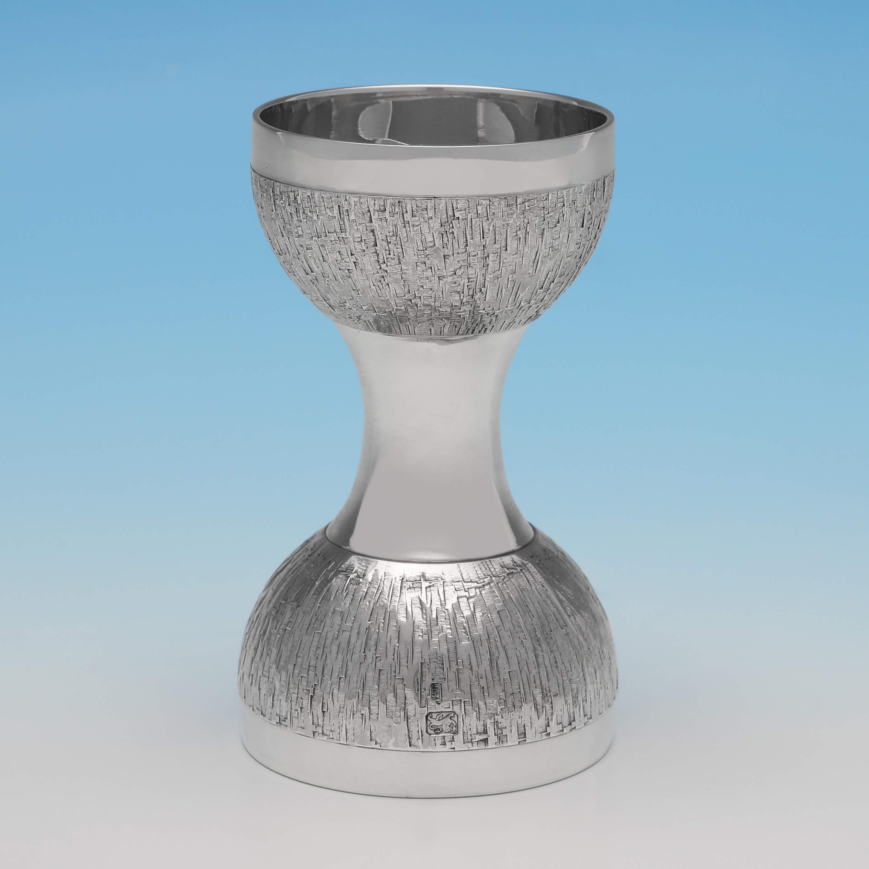 Hallmarked in London in 1971 by C. J. Vander, and designed by Christopher Lawrence, this handsome, Mid-Century Modern Sterling Silver Spirit Measure, is double sided for single and double measures, and features a bark effect finish. The spirit