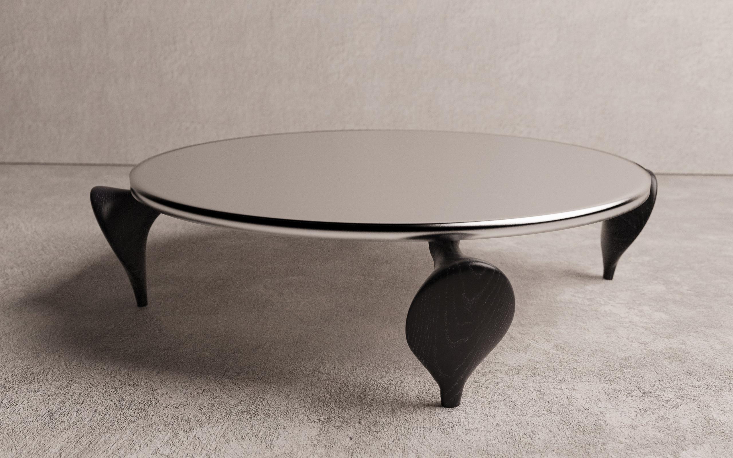 The Aryota Coffee table by Christopher Mark is a hand crafted one of one piece. Christopher was inspired by the contrast of a shape imbedded in a rocky outcropping near the 7/8 shop. The top of the coffee table is made of aluminum with a sandblasted