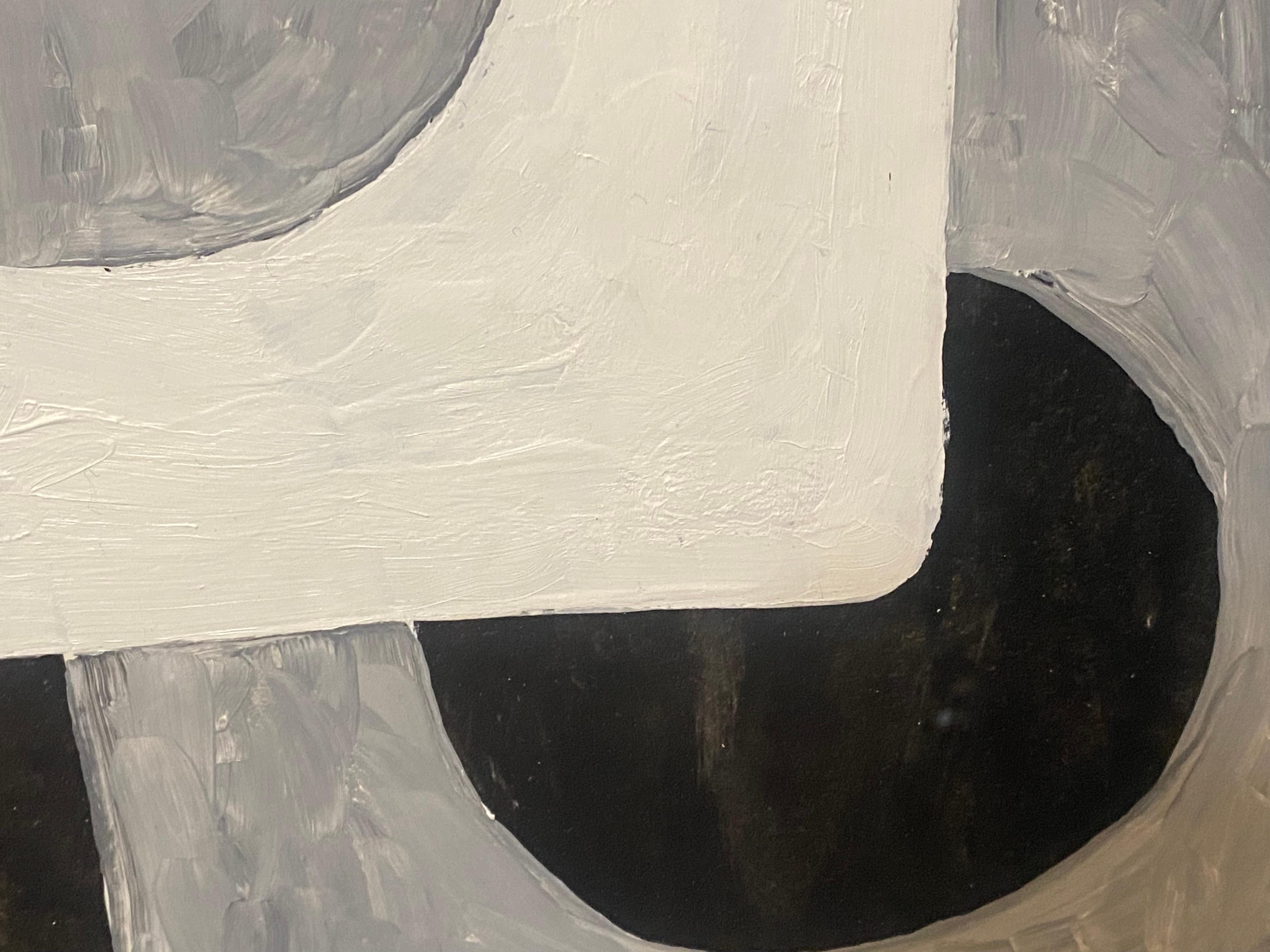 Against a black background, textured like slate, white and gray shapes rise, layered atop one another. In the upper section, a white rectangle casts a shadow that intersects a first square, hollowed at its center, which in turn engages with the