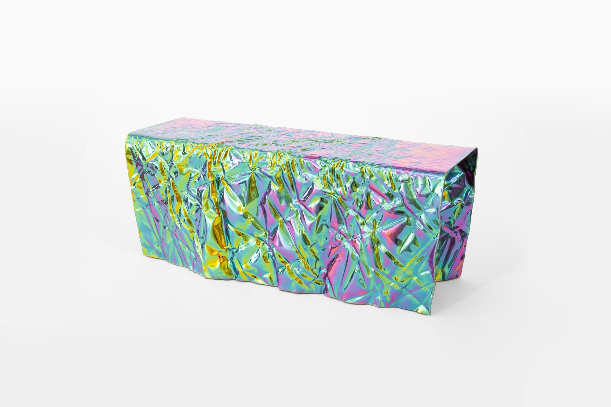 Wrinkled steel bench by Omaha-based designer Christopher Prinz, who achieves this unusual texture by repeatedly creasing a thin sheet of steel, resulting in a strong, rigid, and unique form. Hidden leveling feet protect surfaces and ensure