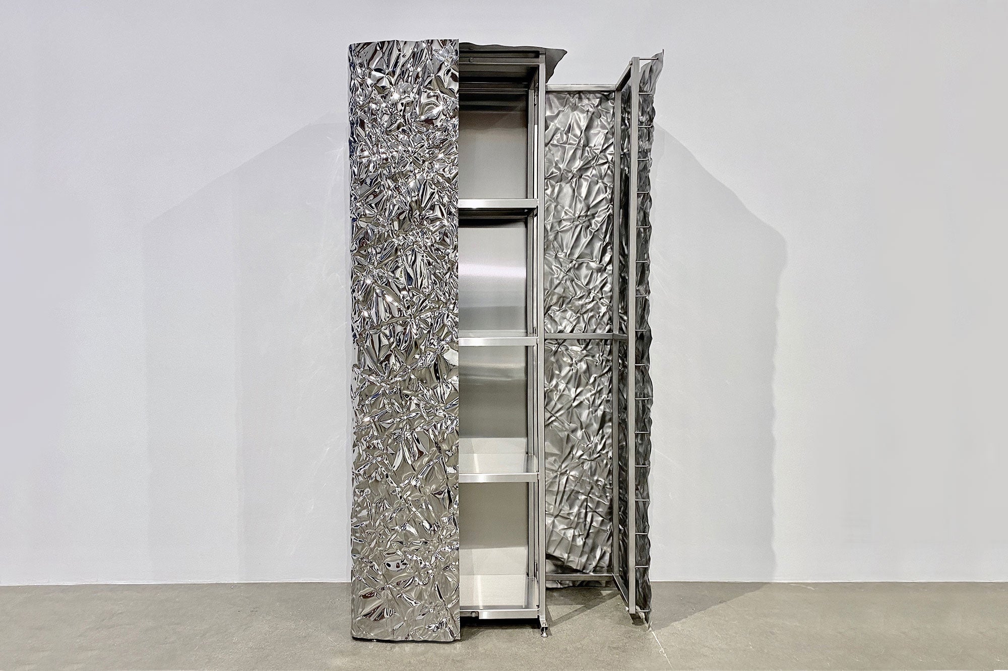 Stunning wrinkled steel cabinet with mirror polished plating and interior shelving by Omaha-based designer Christopher Prinz. Made to order with a lead time of 10-12 weeks. Available in a range of raw and polished finishes. Please note that pieces