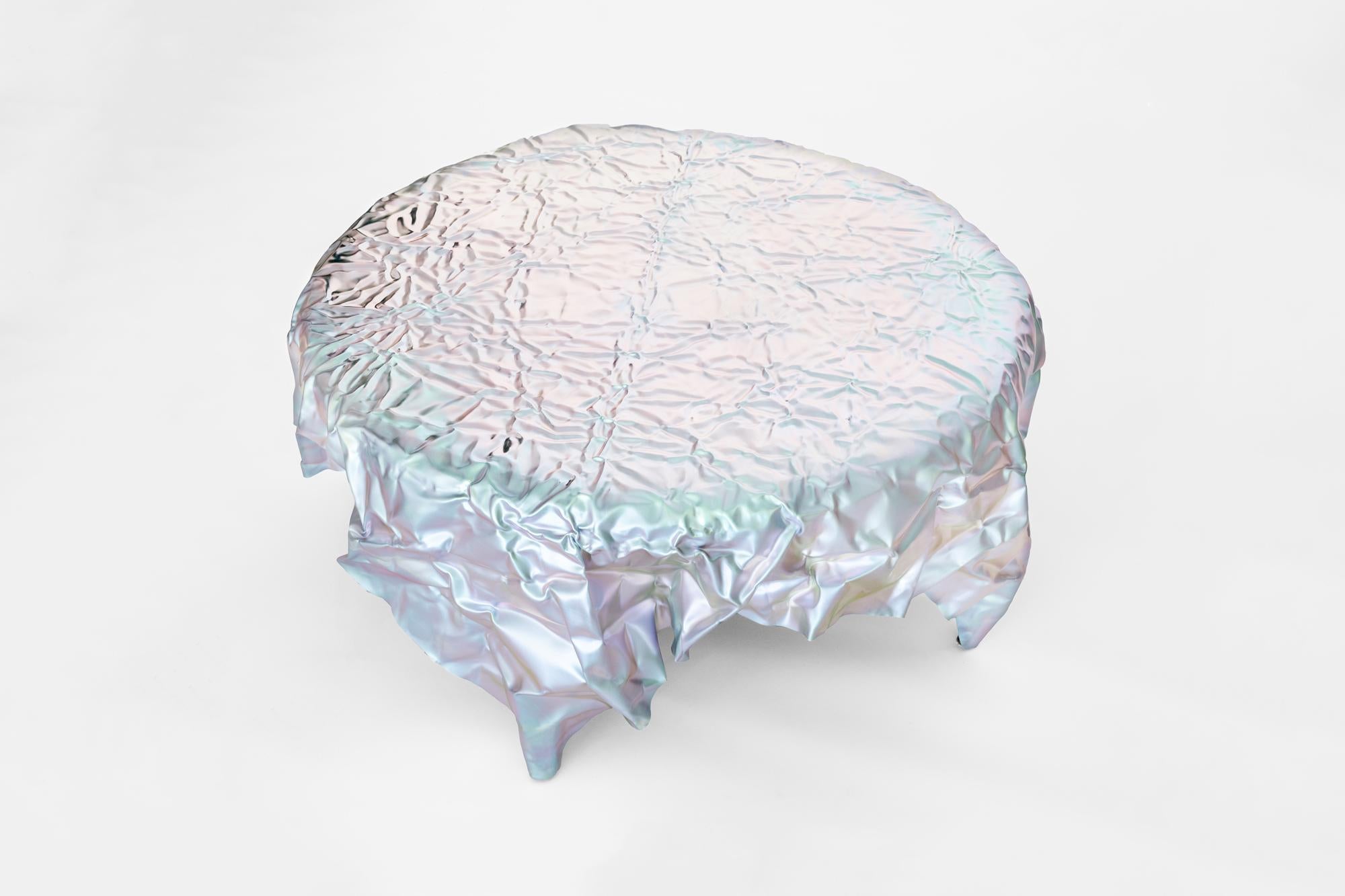 Wrinkled steel coffee table by Omaha-based designer Christopher Prinz, who achieves this unusual texture by repeatedly creasing a thin sheet of steel, resulting in a strong, rigid, and unique form. Hidden leveling feet protect surfaces and ensure