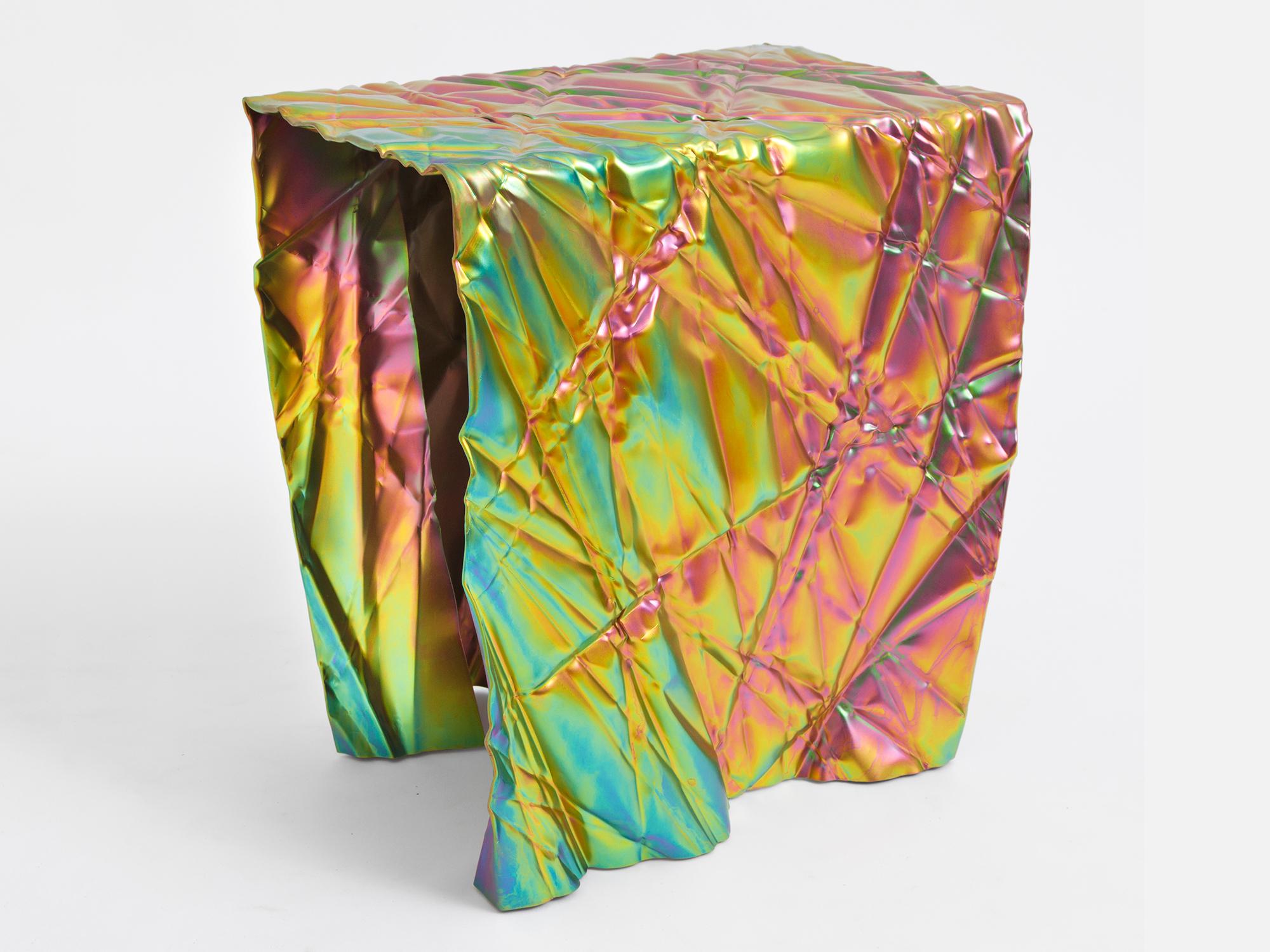 Wrinkled stool or side table by Omaha-based designer Christopher Prinz, who achieves this unusual texture by repeatedly creasing a thin sheet of steel, resulting in a strong, rigid, and unique form. Hidden leveling feet protect surfaces and ensure