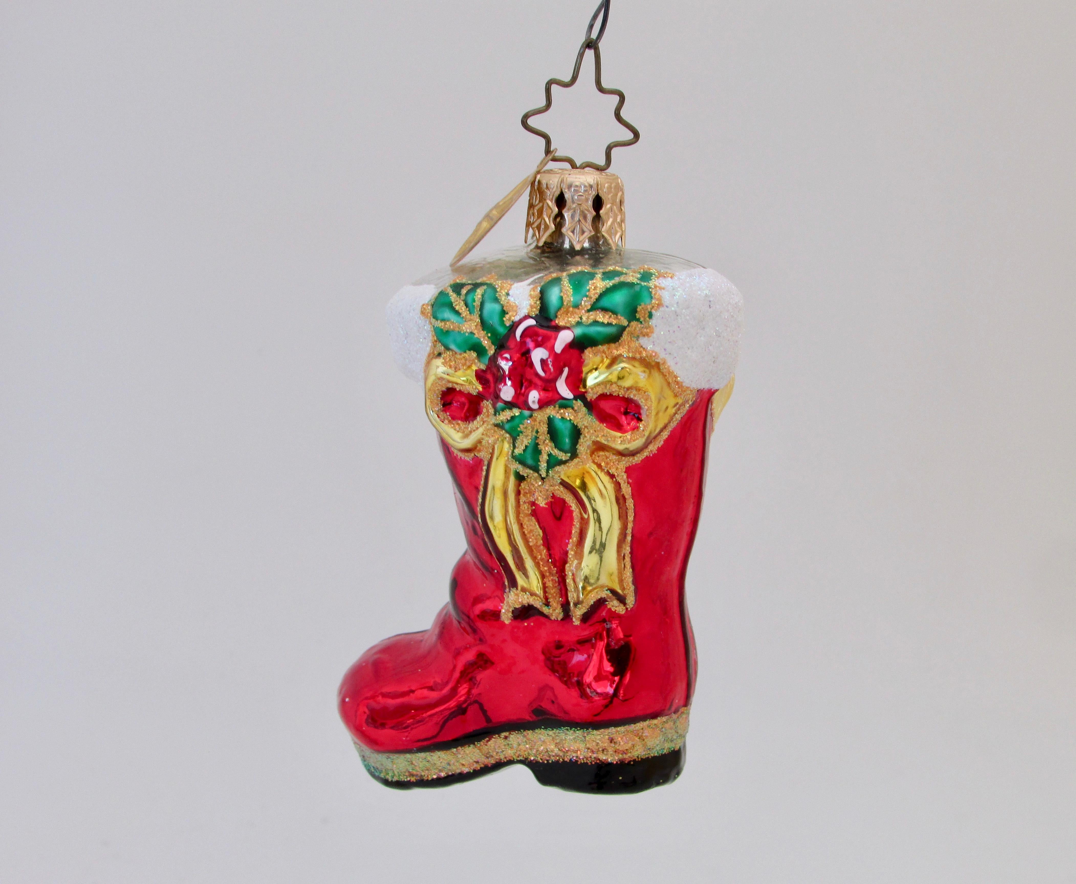 Vintage Christopher Radko Christmas little gem ruby bootie ornament with gold bow and mistletoe on both sides and glitter at the top and bottom. A Christmas gem indeed for your tree or as a gift.

Family-owned European factories use centuries-old