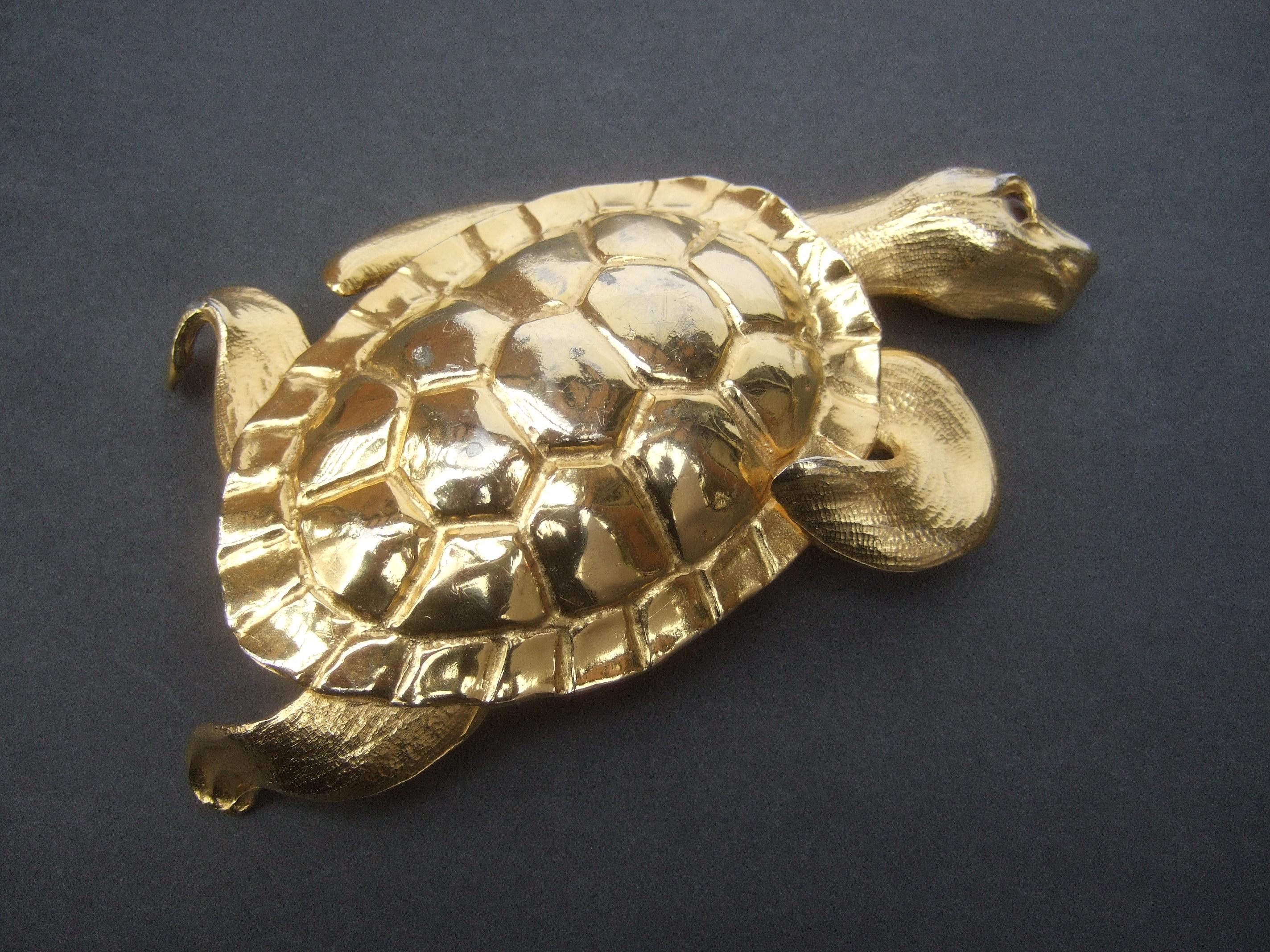 Christopher Ross Massive huge-scale  24k gold plated turtle belt buckle c 1980s
The humongous large size belt buckle is designed with a stylized turtle figure
The turtle's shell is sheathed with shiny gilt metal plating. In contrast the turtle's
