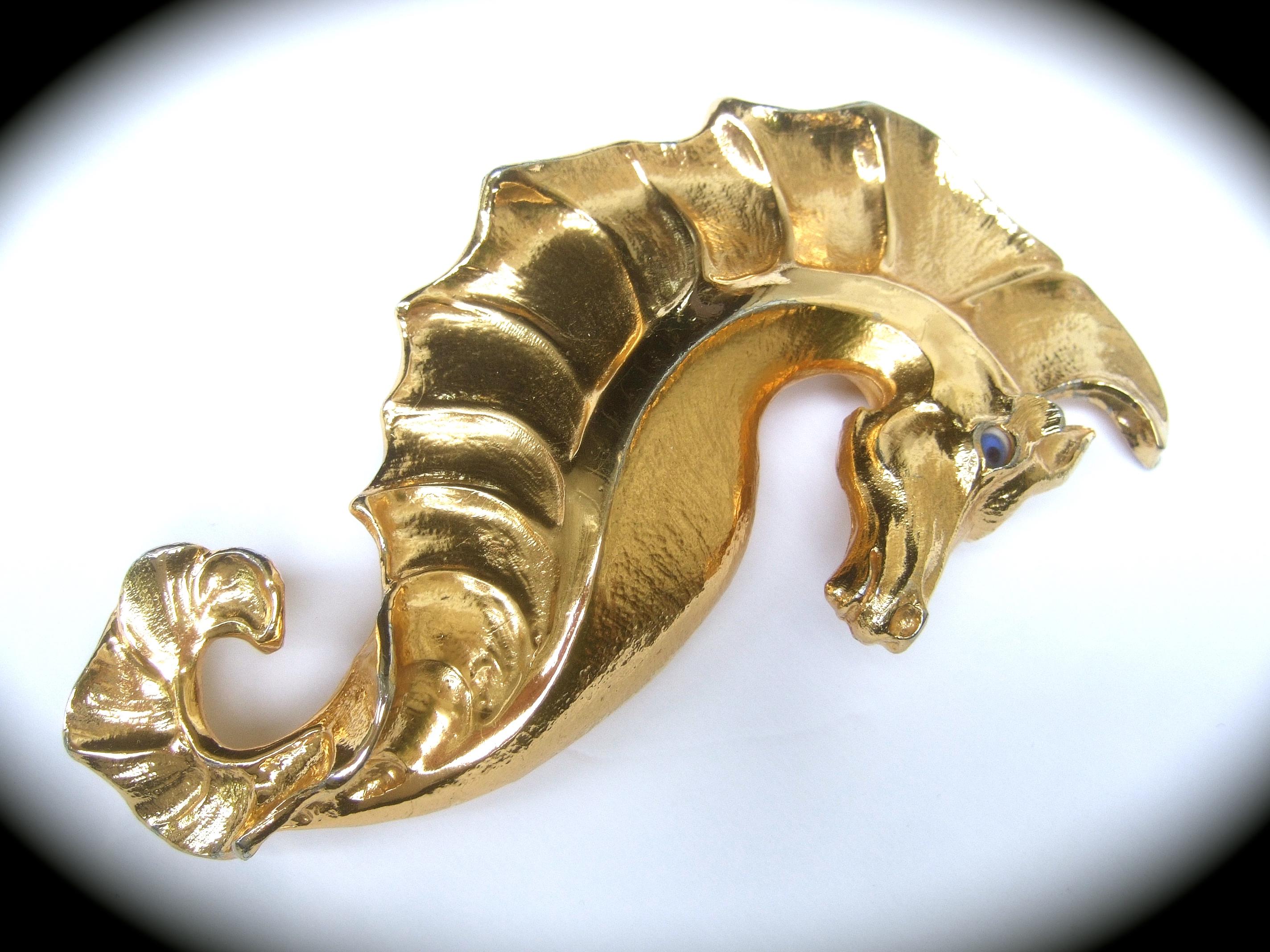 Christopher Ross Rare massive 24k gold plated seahorse artisan belt buckle c 1980s 
The incredible huge scale stylized seahorse belt buckle is sheathed in luminous 24k gold plating
Embellished with a blue glass eye

The seahorse buckle when mounted