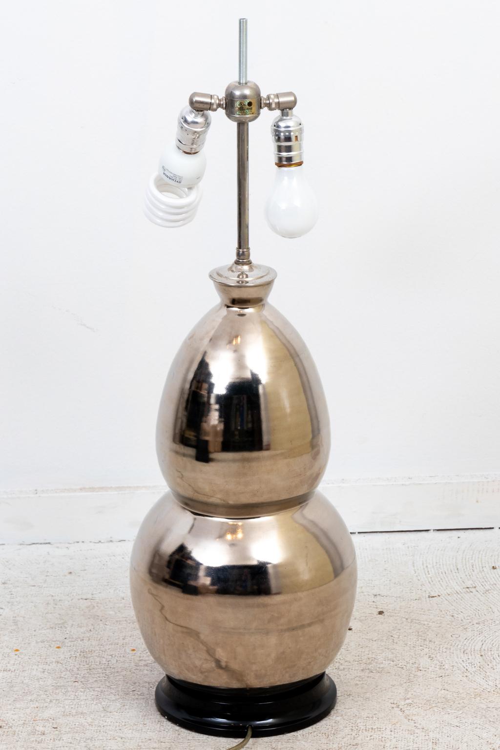 Silver gourd form table lamp made by Christopher Spitzmiller in the early 2000s. The piece features a black wood painted base. Made in the United States. Shade not included. Please note of wear consistent with age including minor scratch to the