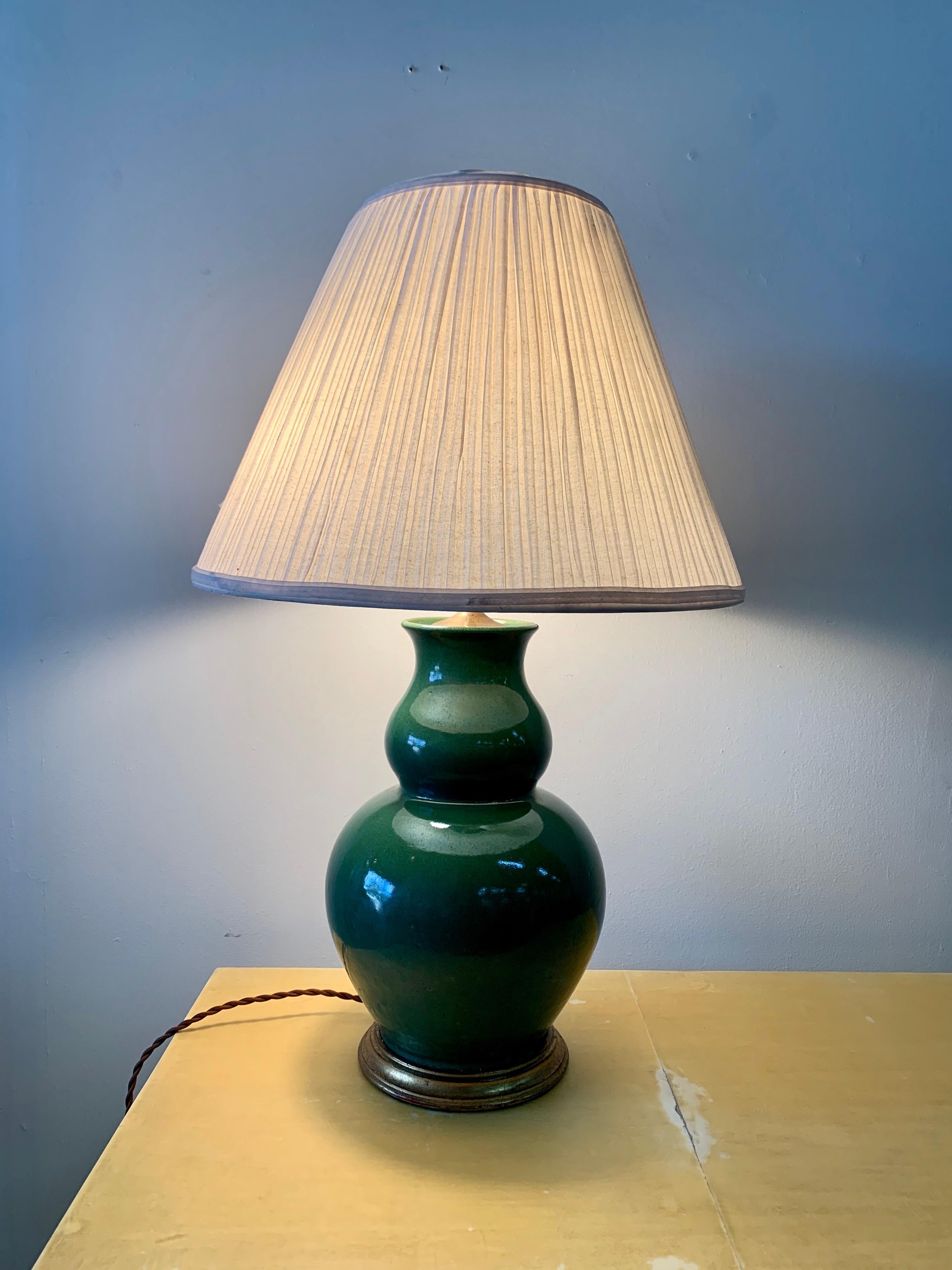 This double gourd shape in a beautiful jade green tone, this porcelain lamp with double sockets and new silk wiring. Shade is original with heavy spots from age - included if you want it.