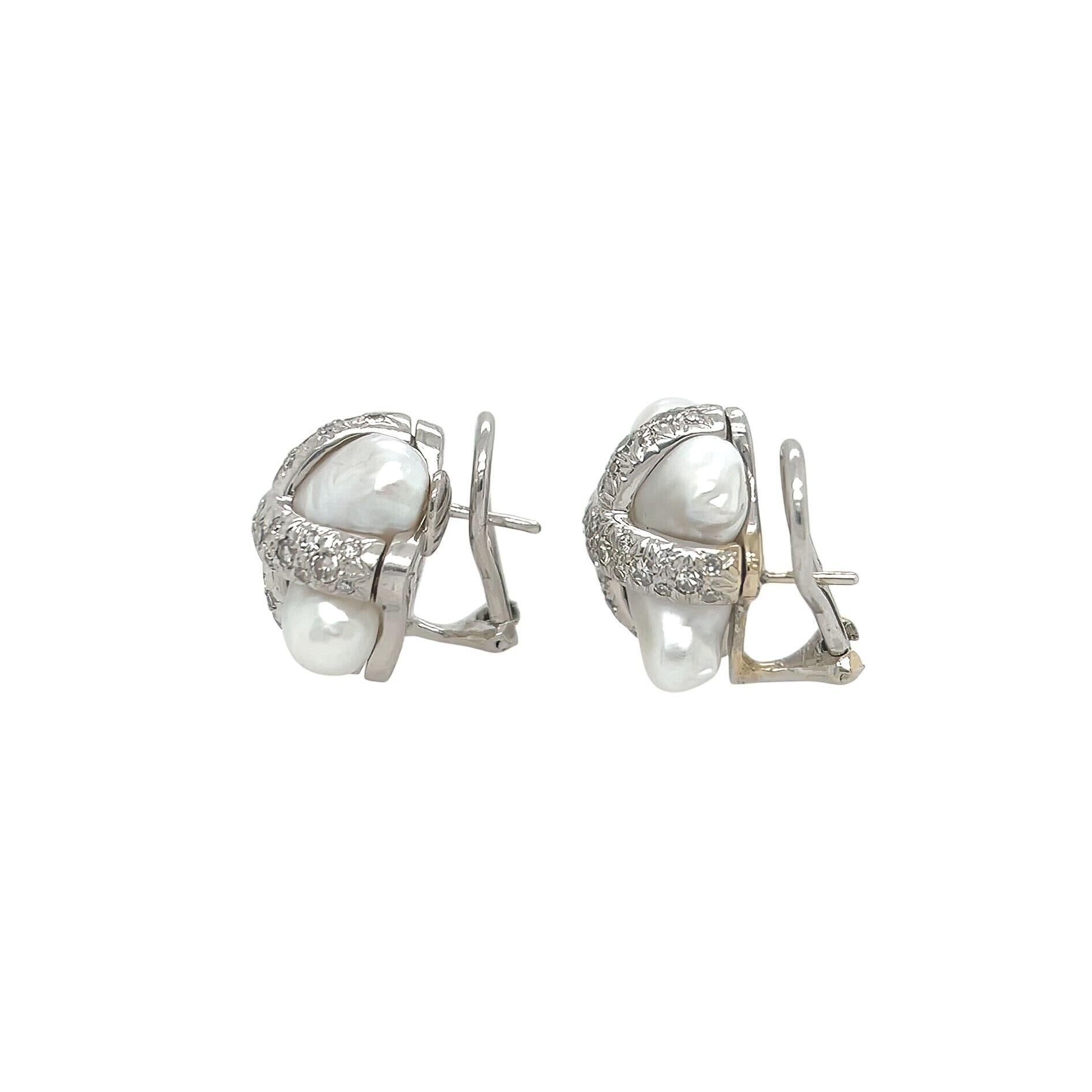 A pair of 14 karat white gold, pearl and diamond earrings, Christopher Walling.  Each earring designed as an X shaped Biwa pearl overlaid by an X set with approximately 41 round brilliant cut diamonds, with post and clip back.  Total diamond weight