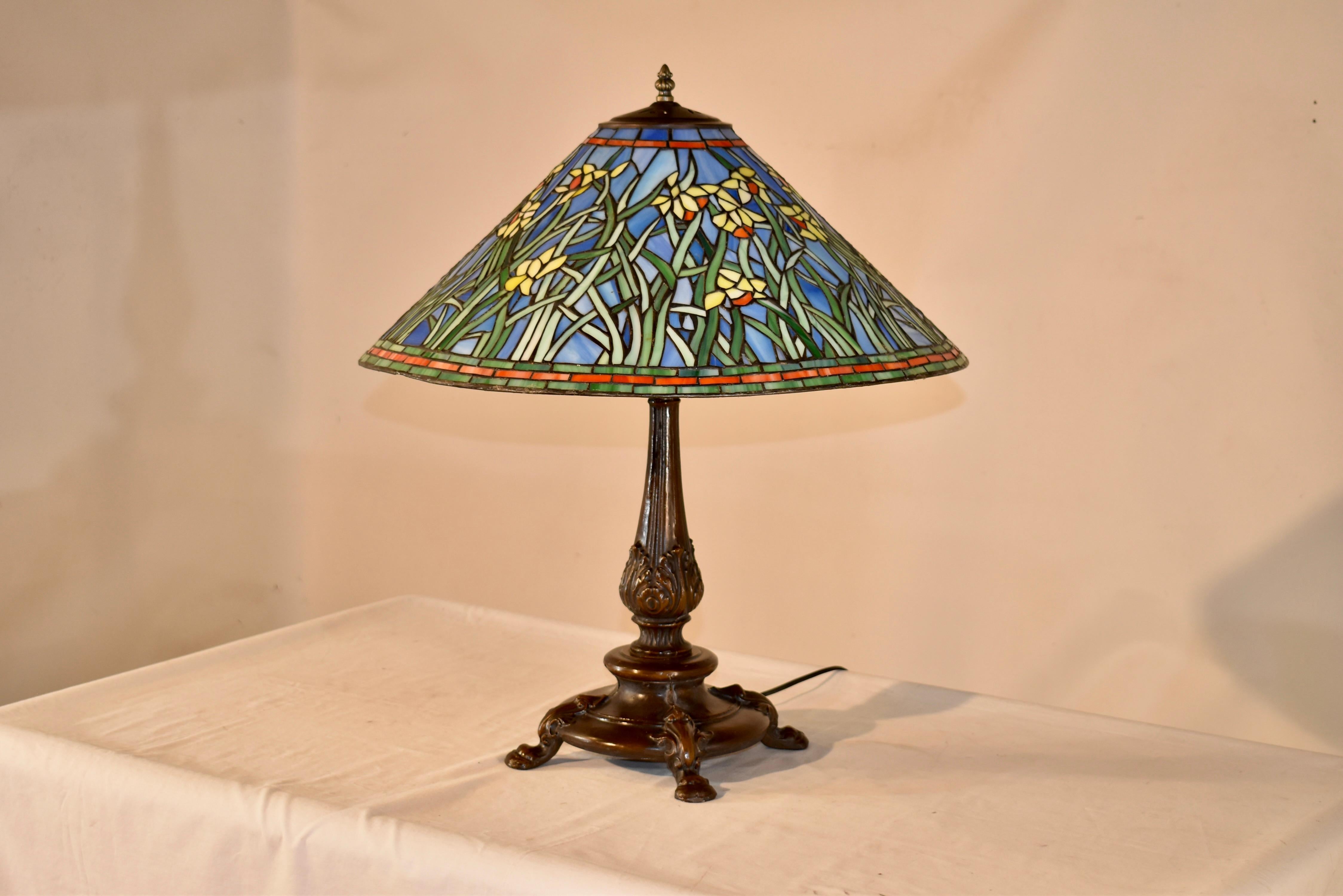 Fabulous handcrafted table lamp by Christopher Wray in England.  This lamp is one of very few examples we have ever had the pleasure to be able to offer.  The shade is lovely and is in a pattern of daffodils, growing wildly all over the shade, which