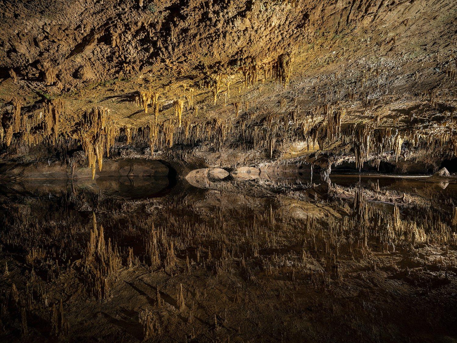 "RESPLENDENCE OF ANTIPODES
In the scope of civilization, the subterranean realm remains largely unchanged. Isolated in darkness for hundreds of millions of years, the sunless underworld encompasses majestic ancient formations gradually eroded into