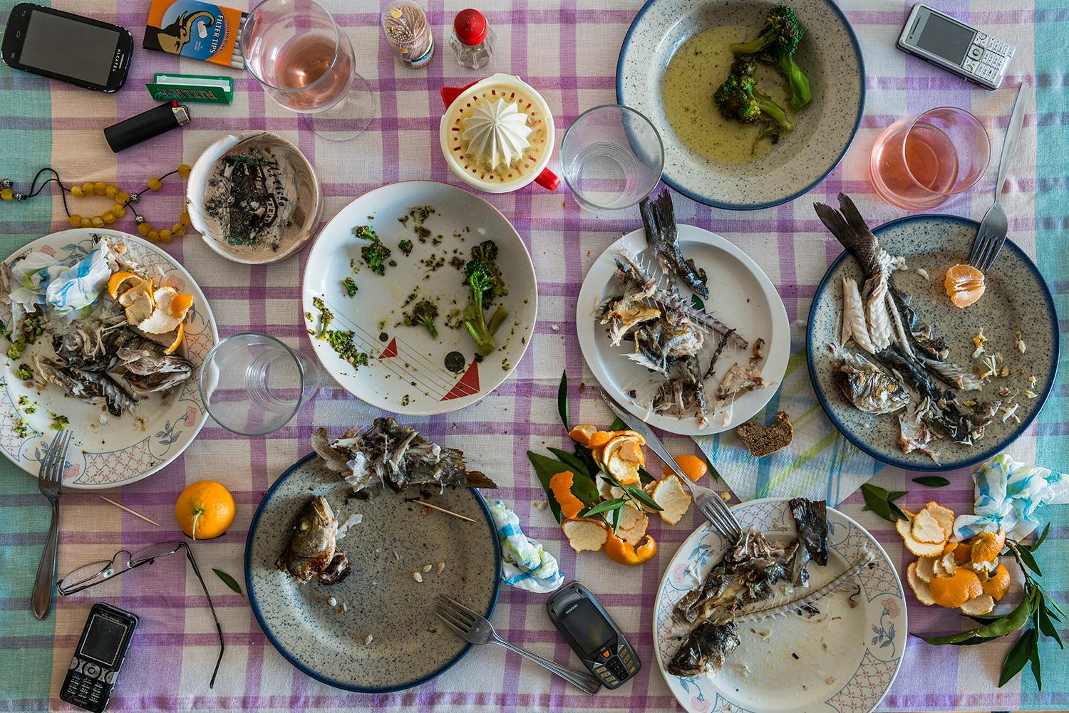This photograph belongs to the series "Conversations." Evoking Dutch still-life as inspiration, these beautiful, contemporary tabletops contemplate technology's implications upon human interaction and memory. Shared meals with friends and family