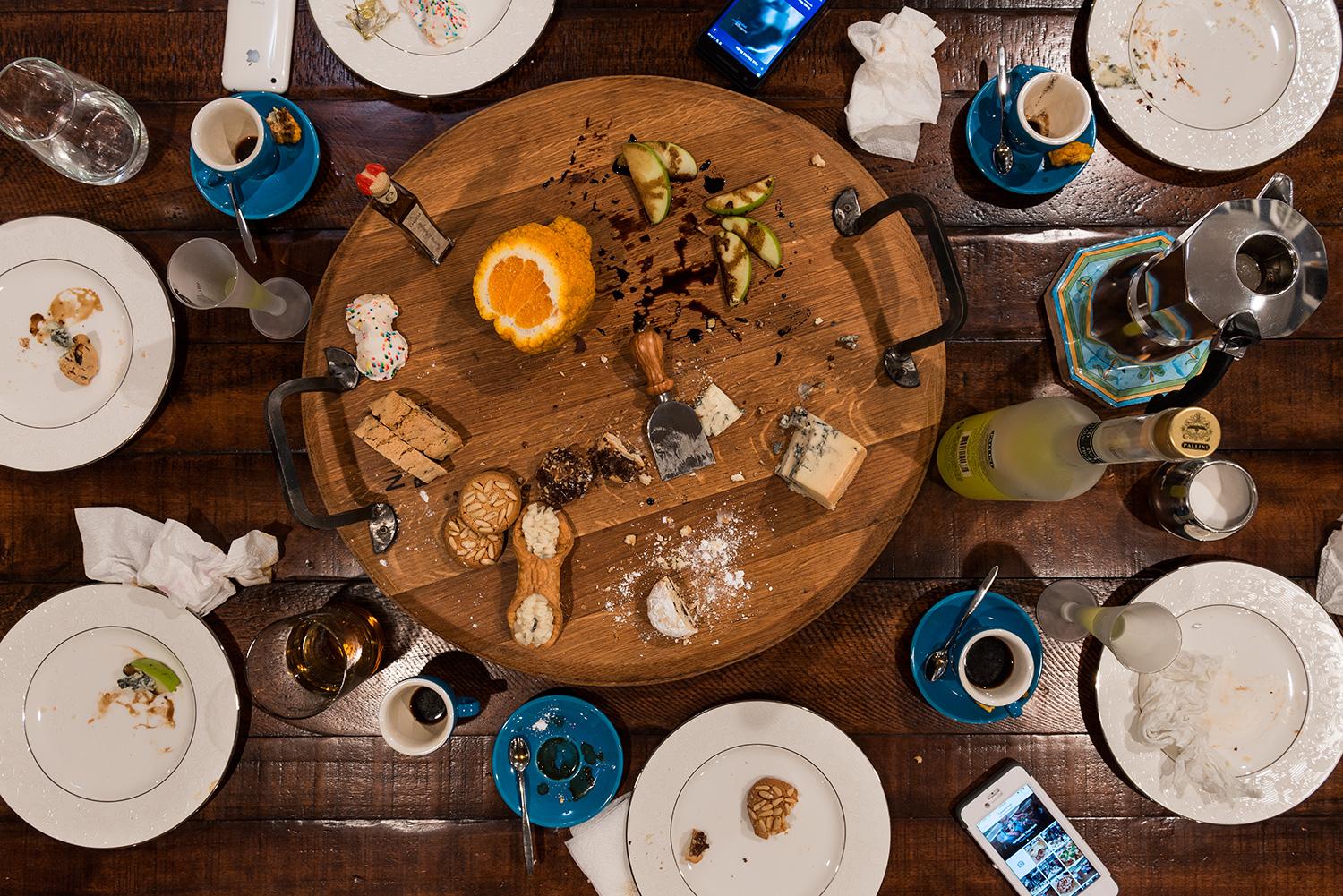 This photograph belongs to the series "Conversations." Evoking Dutch still-life as inspiration, these beautiful, contemporary tabletops contemplate technology's implications upon human interaction and memory. Shared meals with friends and family