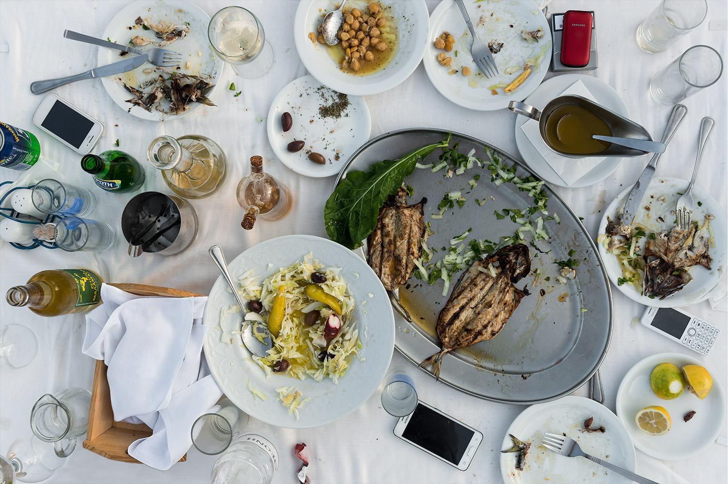 This photograph belongs to the series "Conversations." Evoking Dutch still-life as inspiration, these beautiful, contemporary tabletops contemplate technology's implications upon human interaction and memory. Shared meals with friends and family