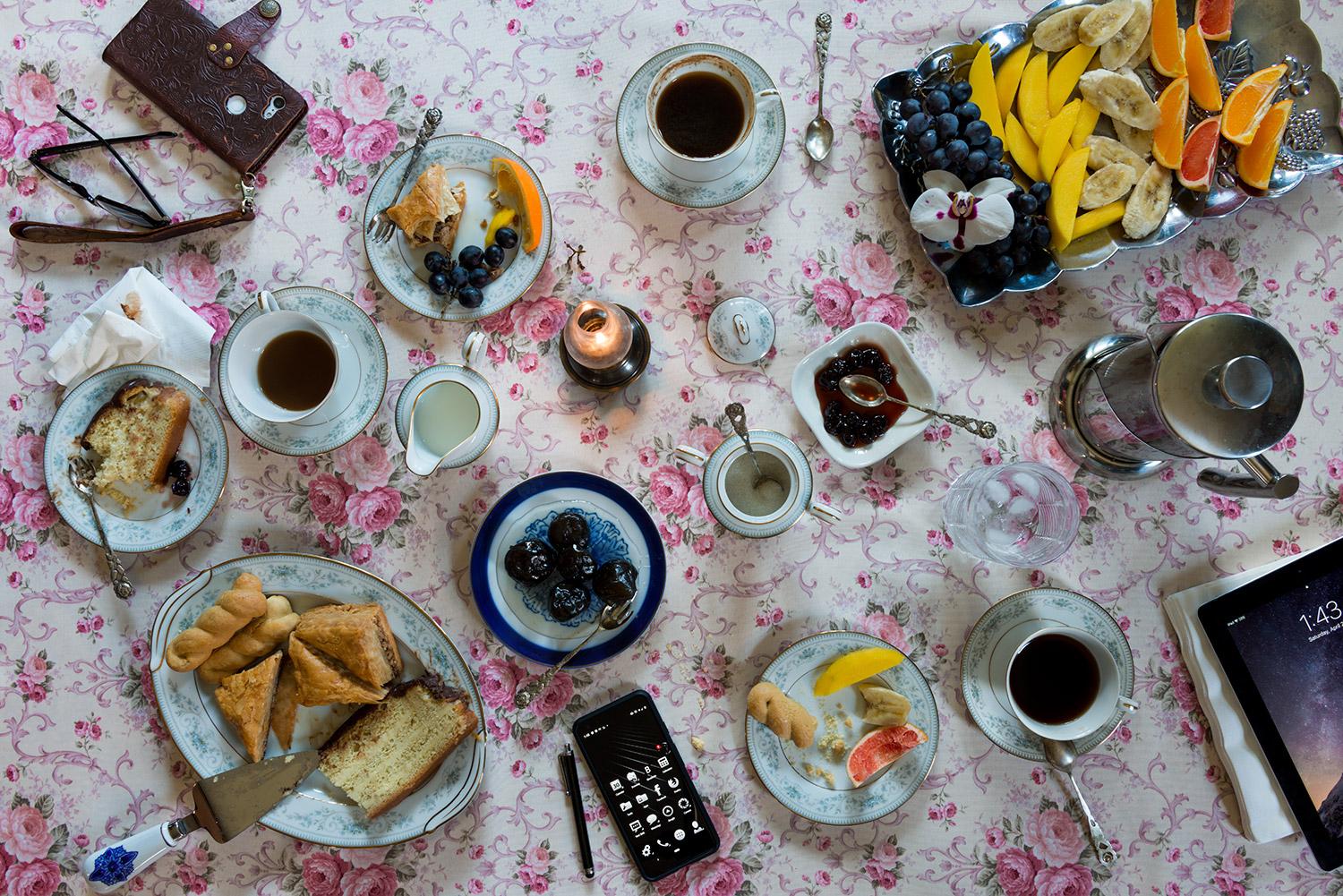 This photograph belongs to the series "Conversations." Evoking Dutch still-life as inspiration, these beautiful, contemporary tabletops contemplate technology's implications upon human interaction and memory. Shared meals with friends and family