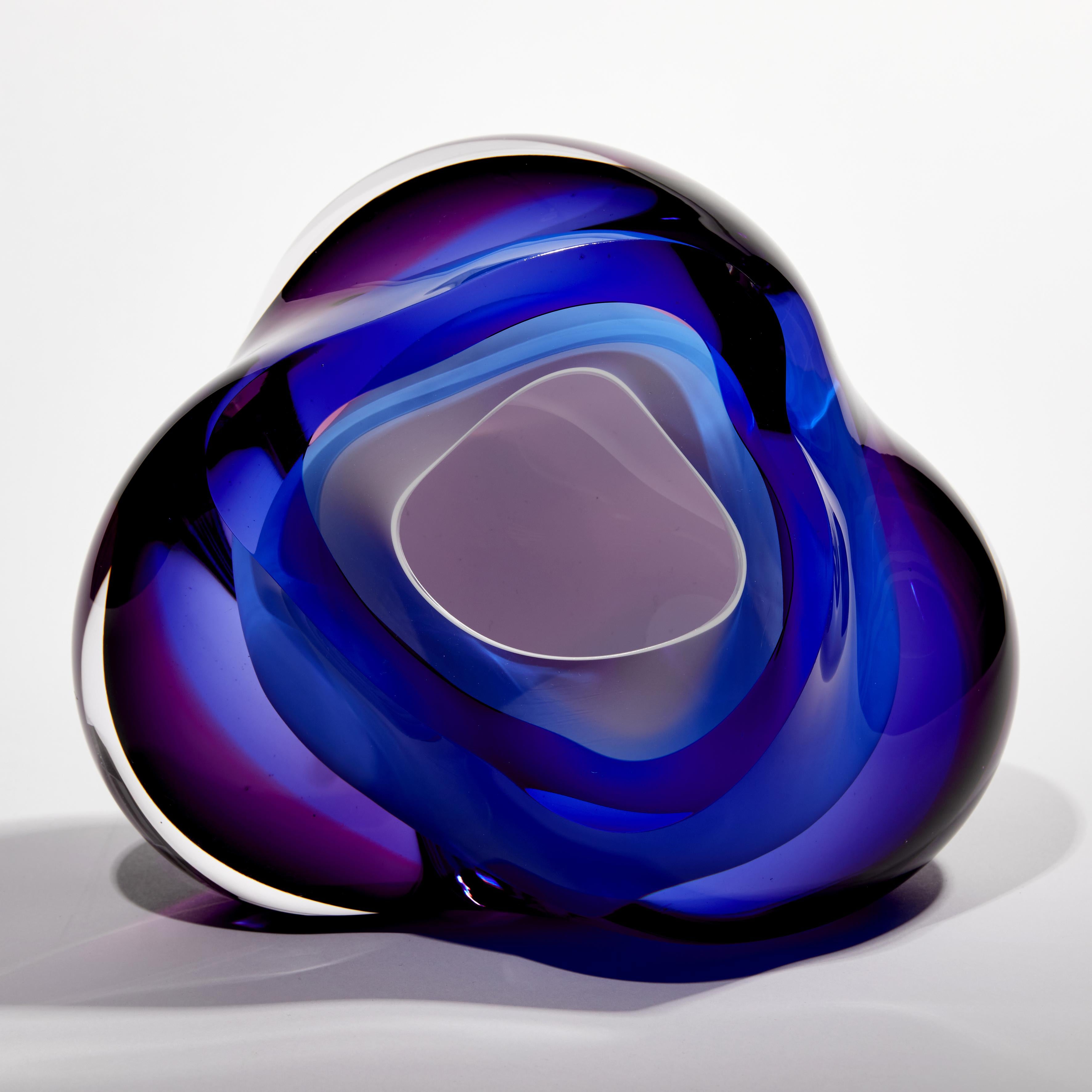Chromatic Vug in Blue & Fuchsia II is a unique handblown sculpture by the British artist Samantha Donaldson. An intense mass of blue and purple contrast with the soft white interior. Taking inspiration from rock formations, geodes and the treasures