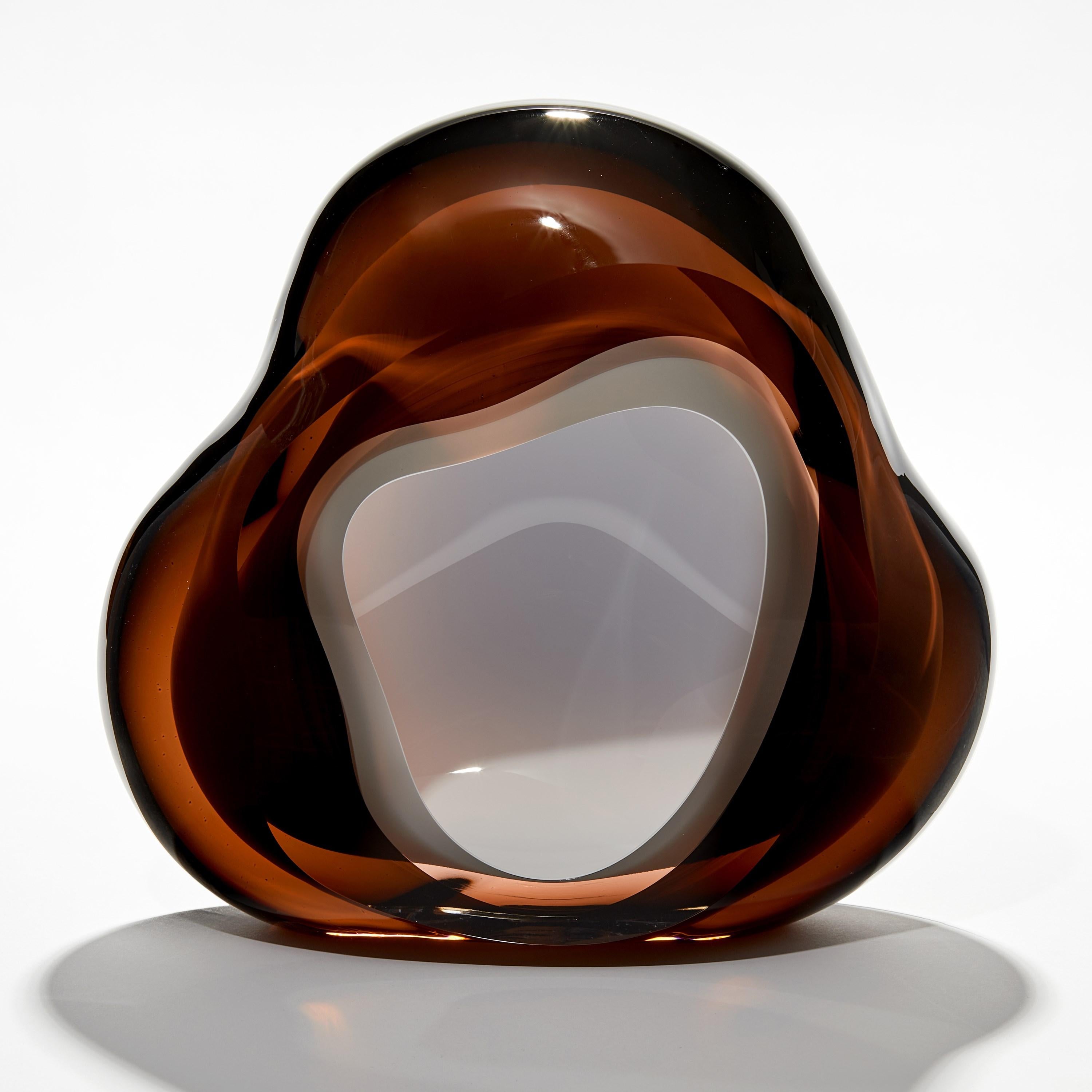 'Chromatic Vug in Dark Amber to Olive' is a unique handblown sculpture by the British artist, Samantha Donaldson.

Created by layers of coloured glass, the transparent colours merge and create further hues throughout the piece. An additional