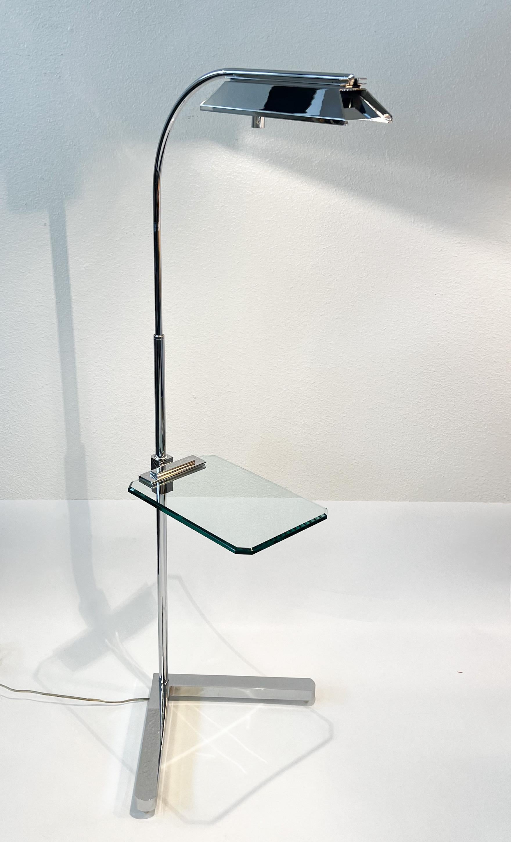 1970’s Polish chrome adjustable floor lamp with cantilever occasional glass table  by Casella Lighting. 

In good original vintage condition with minor wear consistent with age. Some scratches underneath the table bracket (see detail photo). 
Wire