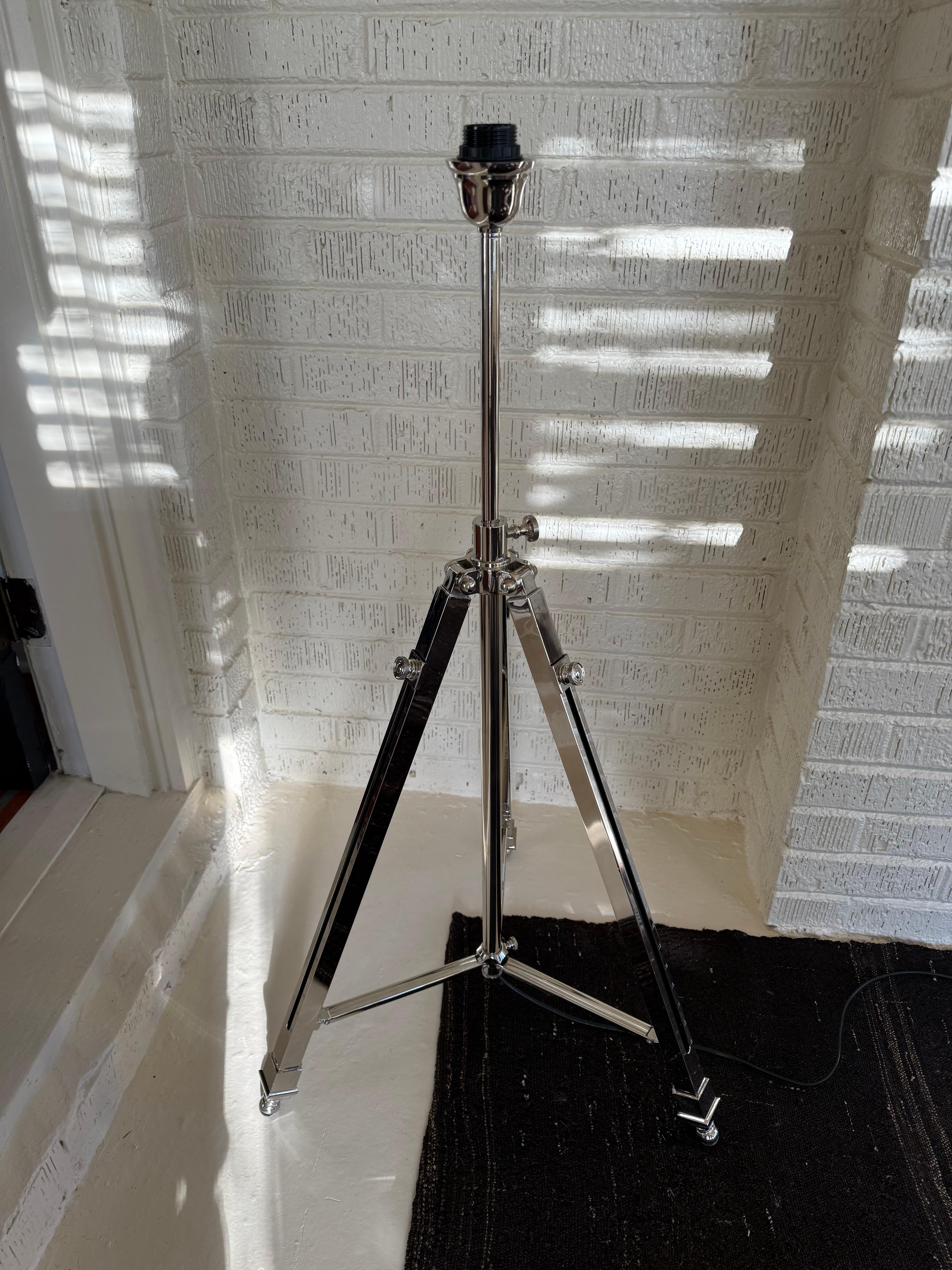 A commanding presence in any space, this oversized adjustable lamp draws inspiration from classic studio and photographic lighting. Crafted in polished chrome, its clean lines and industrial elegance evoke mid-century modern minimalism while