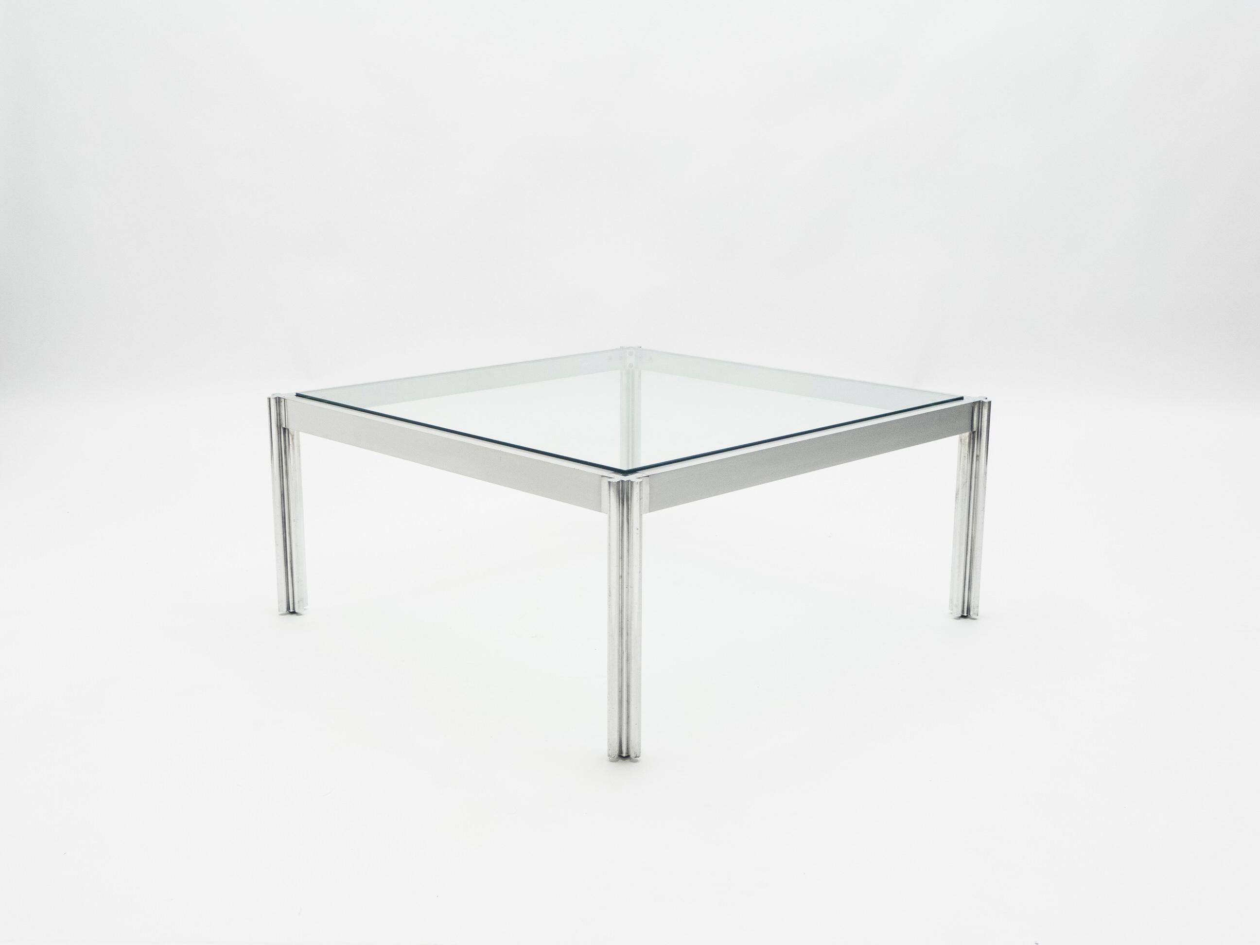 This chrome, aluminum and glass coffee table is a lovely example of clean-lined midcentury design. It was designed by George Ciancimino, the esteemed Algerian-born furniture designer, for French company Mobilier International in 1975. The thick