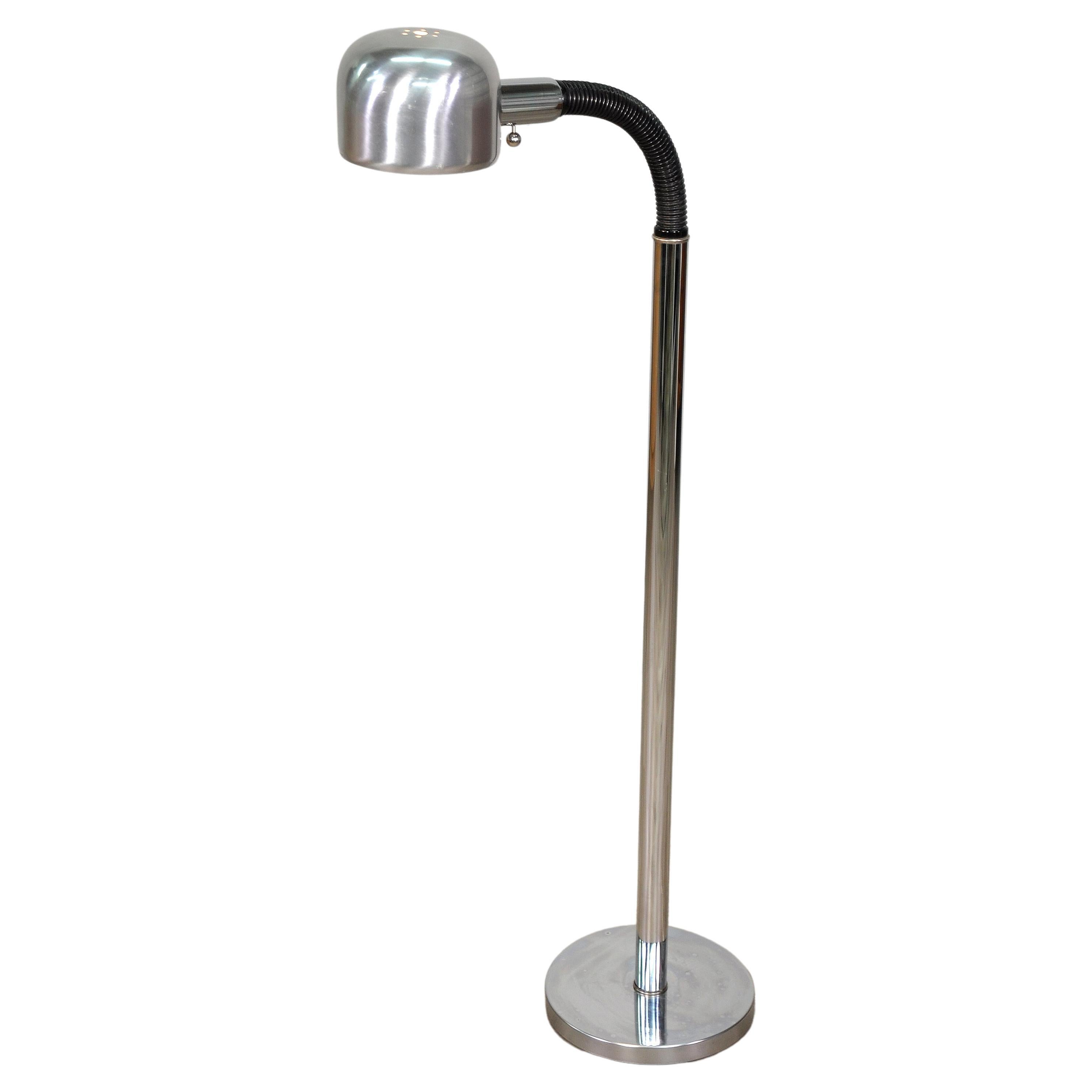 Vintage adjustable gooseneck chrome floor lamp by Alsy Manufacturing. The postmodern lamp features a round base and black articulating neck, making it adjustable to different angles and heights, ranging from 42