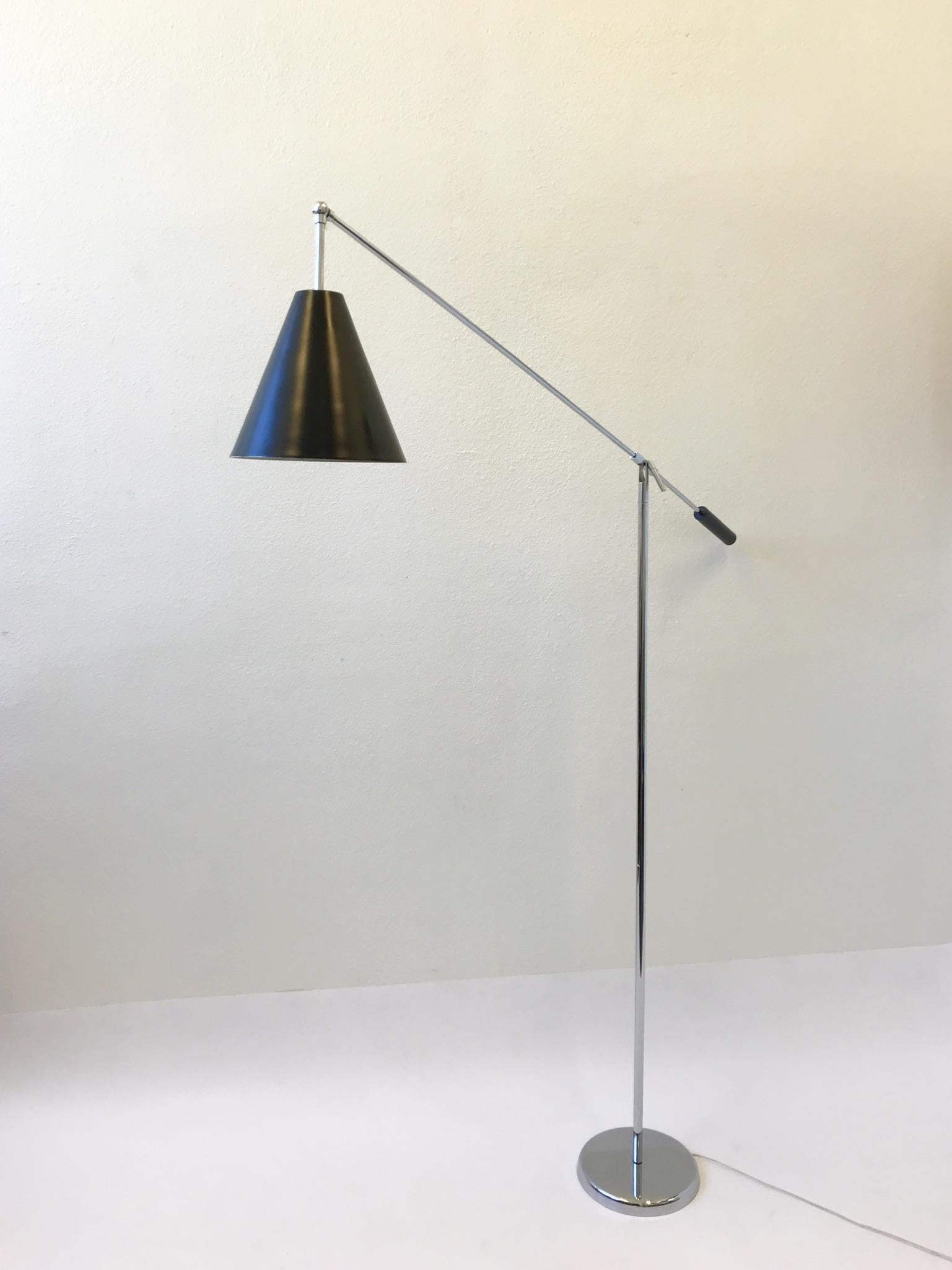 A beautiful polish chrome and black lacquered adjustable floor lamp by Robert Sonneman. The lamp has been newly rewired, but the chrome and the lacquered is in original condition. The lamp shows some minor wear. The arm can be adjusted up and down