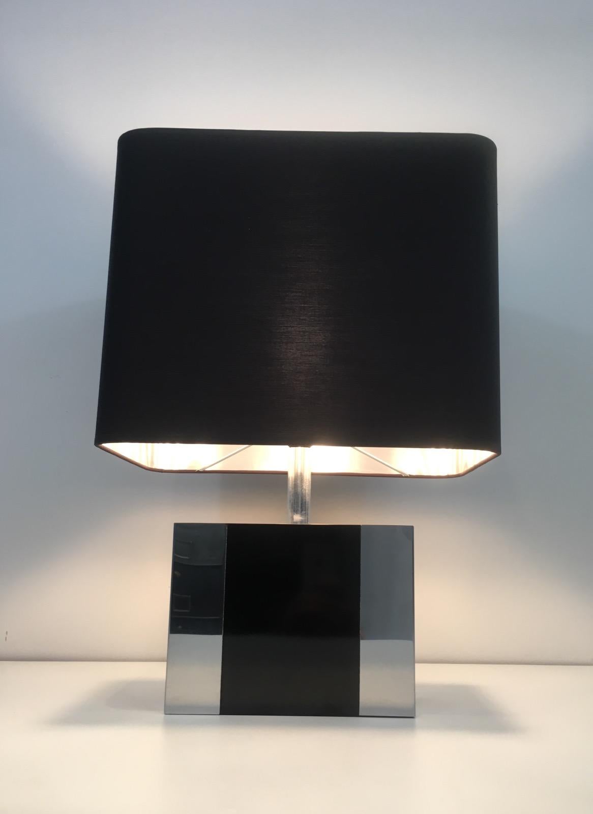This nice table lamp is made of chrome and black lacquered chrome. The lamp has a nice custom black shintz shade, silvered inside. This is a French work, circa 1970.
