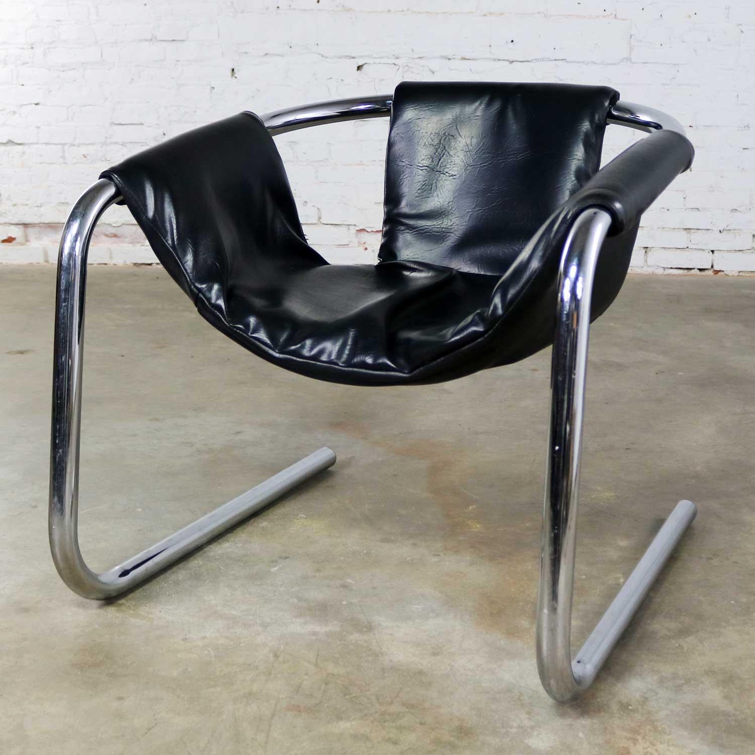 Handsome chrome and black vinyl cantilevered sling chair attributed to Vecta Group of Italy and called the Zermatt chair. This chair is in wonderful vintage condition overall. The chrome is very good but not without a small amount of age appropriate