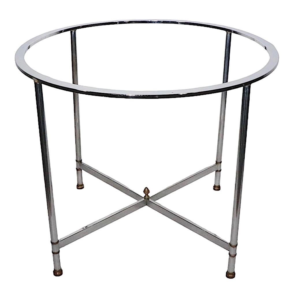 Chic voguish chrome, brass and glass center table, dining table, Made in Italy, circa 1960 -1970s. The table features a bright chrome frame with cast brass fitments, and its' original plate glass top. The table is in very good, original, clean and