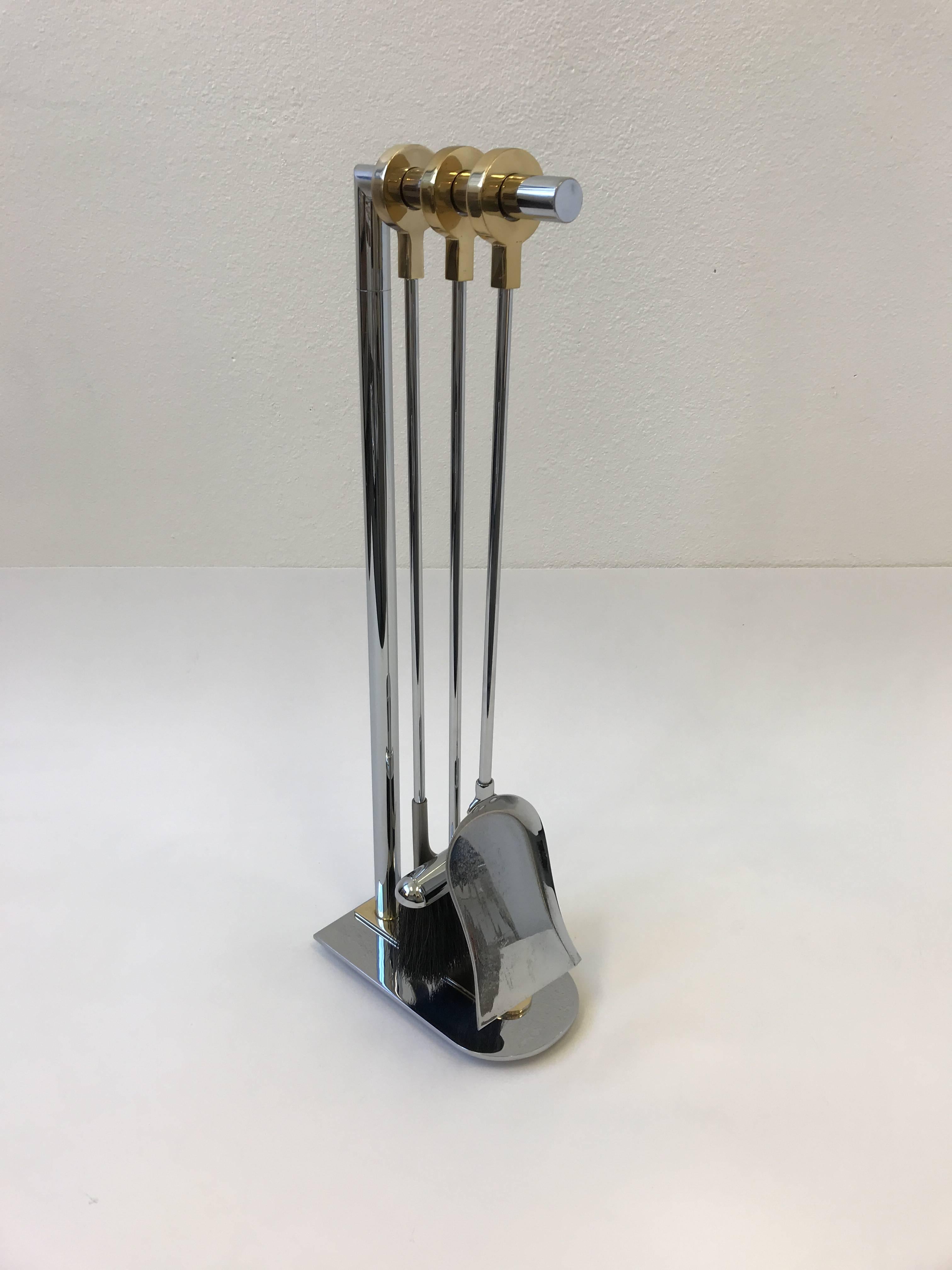 A glamorous 1970s French chrome and brass fireplace tools by Maison Charles. 
Dimensions: 31.5” high 6”deep and 11” wide.