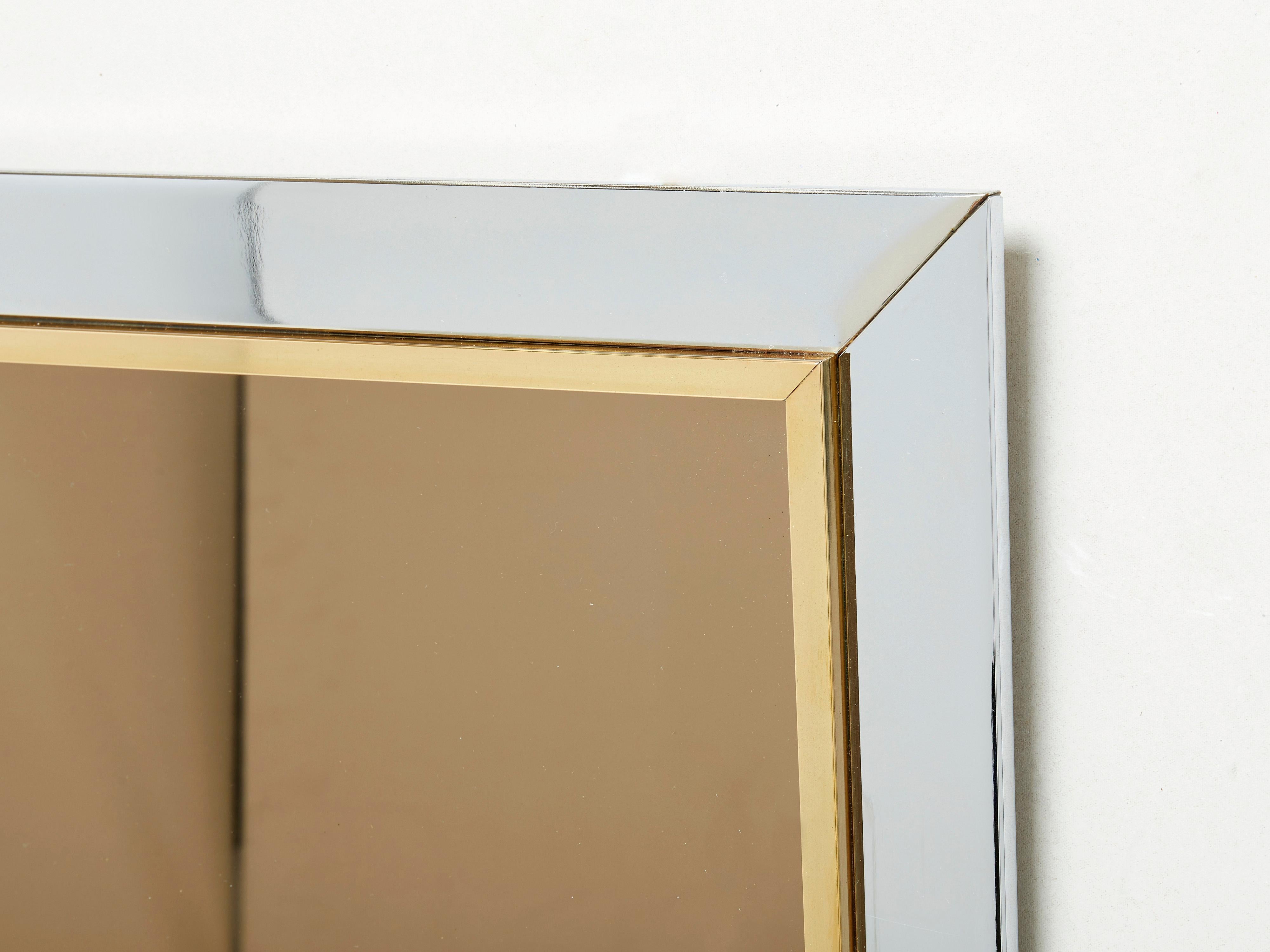 With its strong geometric design, this statement mirror is typical of Belgian design firm Belgo chrome. Its imposing chrome and brass border surrounds the smoky bronze mirror, creating a chic, timeless, 1970s vibes piece. Found in very good vintage