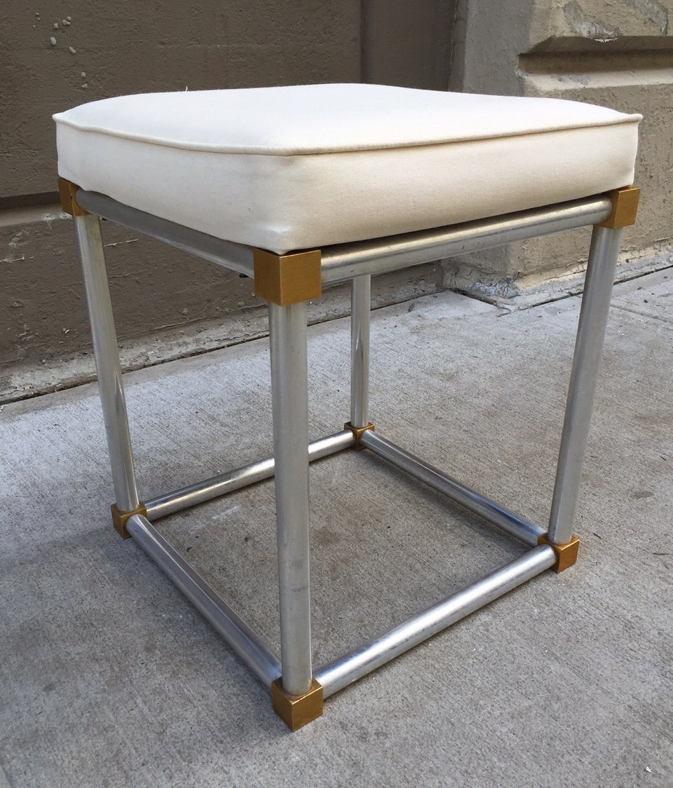 Chrome and brass stool style of Maison Jansen. Seat has a linen blend upholstered seat.
