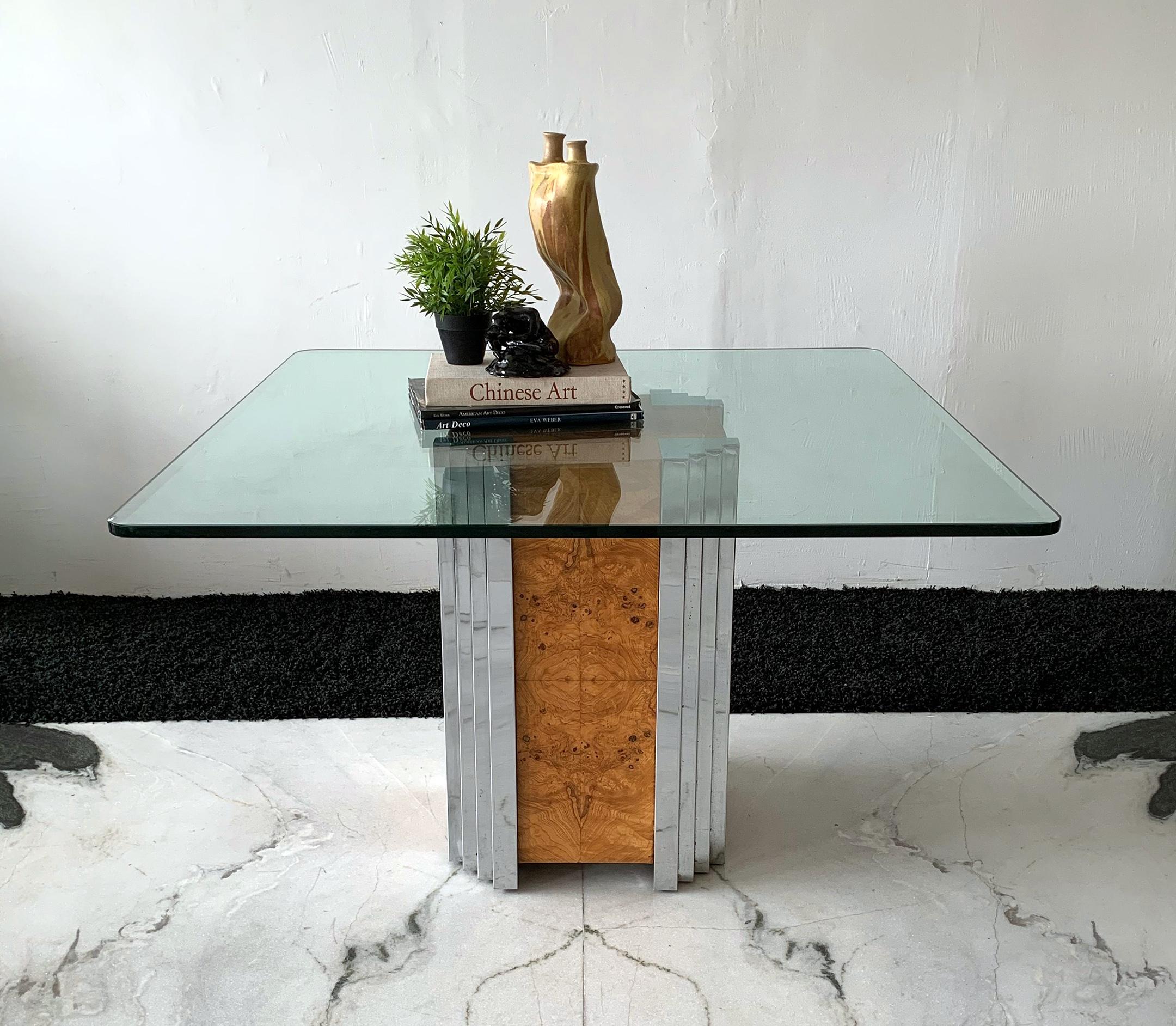 This dining table can be used as a dining table, or a display pedestal. The design is simply divine! Often attributed to Milo Baughman or Leon Rosen for Pace Collection, this Mid-Century Modern pedestal table features book-matched burl sides with