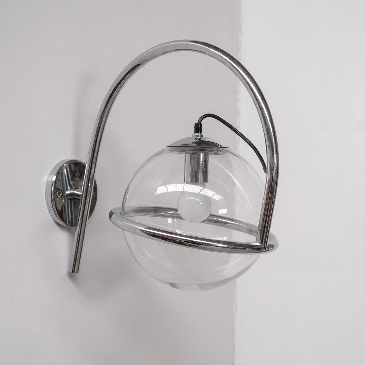 Chrome arm wall light, hosting a clear glass globe shade.

German, circa 1970s.

By Kinkeldey.

THREE AVAILABLE. PRICED AND SOLD INDIVIDUALLY.

Since re-wired and PAT tested.

Location: Belgium Gallery.

Dimensions: 40 H x 28 W x 47 D in
