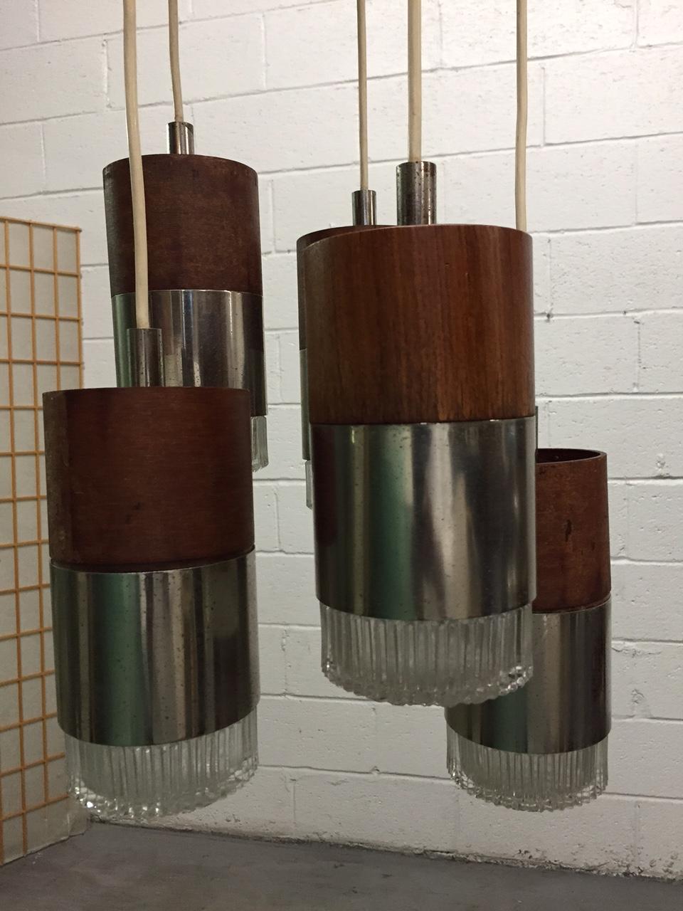 Each cylindrical pendant is chrome with faceted glass.
Measures: 35 height (from top of cap to bottom) Each cylinder is 8 height x 4 in diameter. The ceiling cap is 11 inches in diameter.