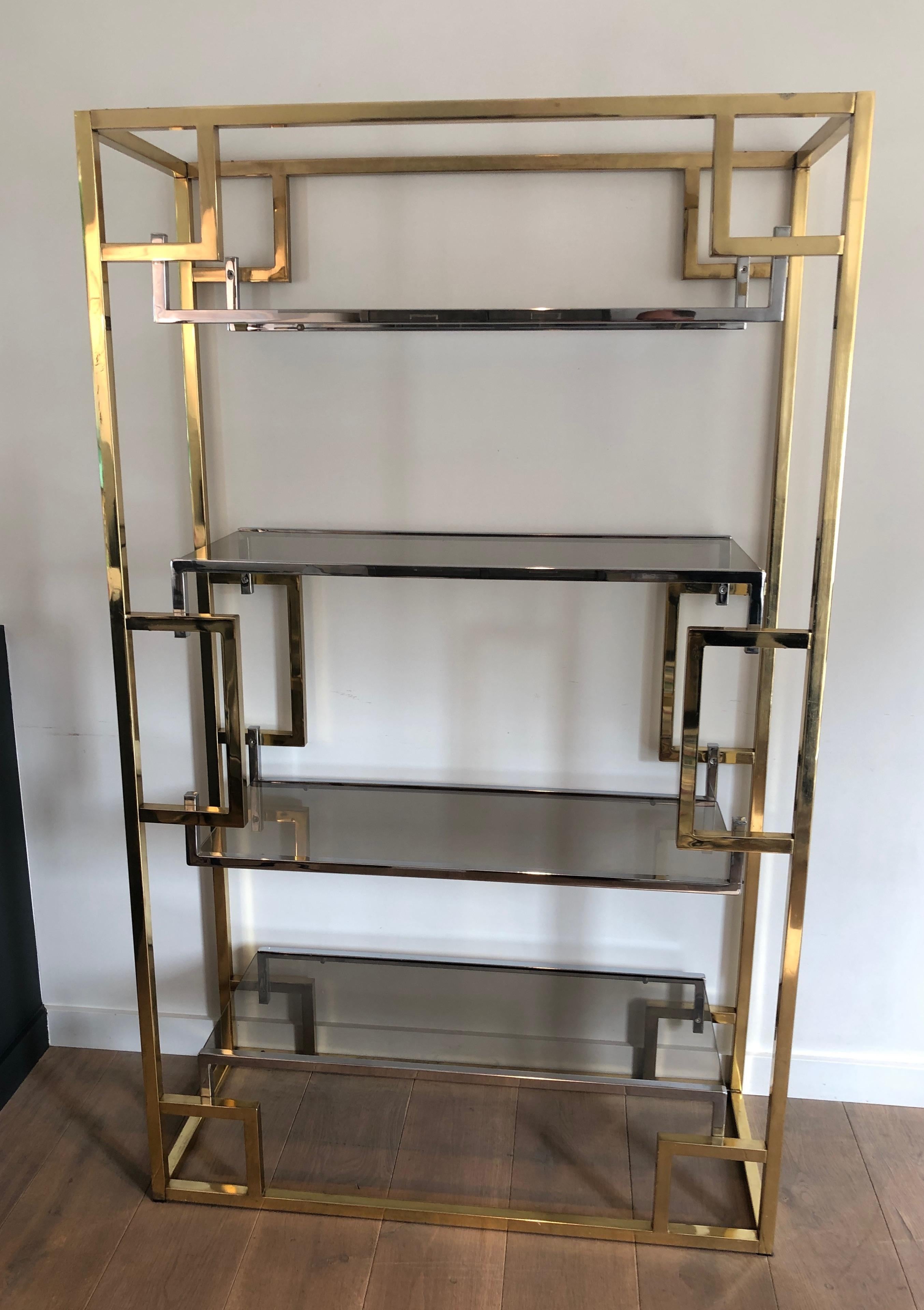 This beautiful shelves unit is made of chrome and gilt chrome. This is a French work in the style of famous designer Willy Rizzo. Circa 1970