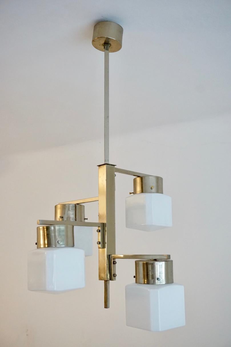 Chrome and glass chandelier in the Bauhaus style, from Czechoslovakia, 1930s

This is a notable example of the modernist Czech design of the 1930s. 
The lamp is distinct because of its minimal, nearly constructivist design style. The original