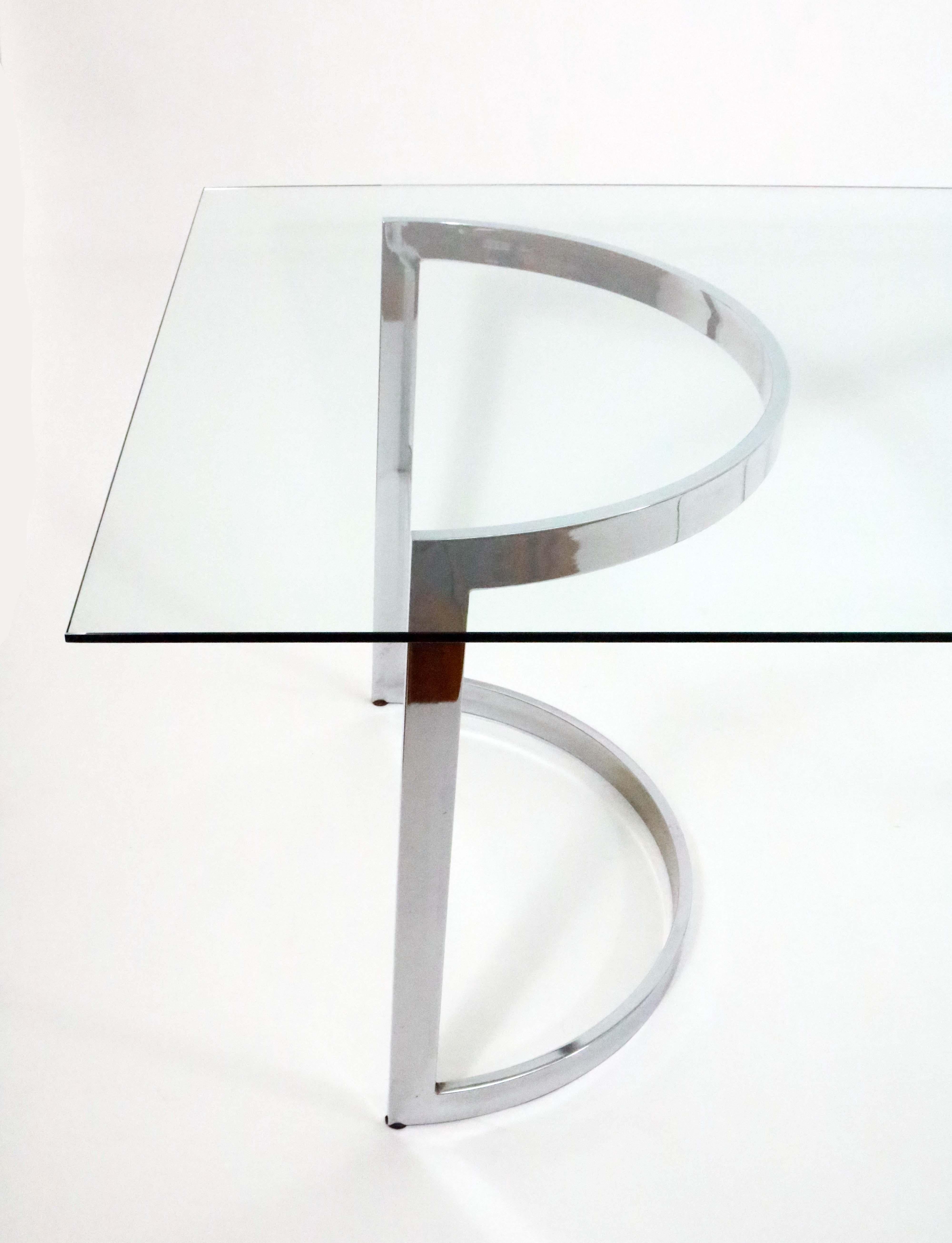 A chromed steel and glass dining table by Cal-Style

The glass top rests on a pair of crescent bases, which can be configured facing inwards or outwards. 

Each base dimensions: 32