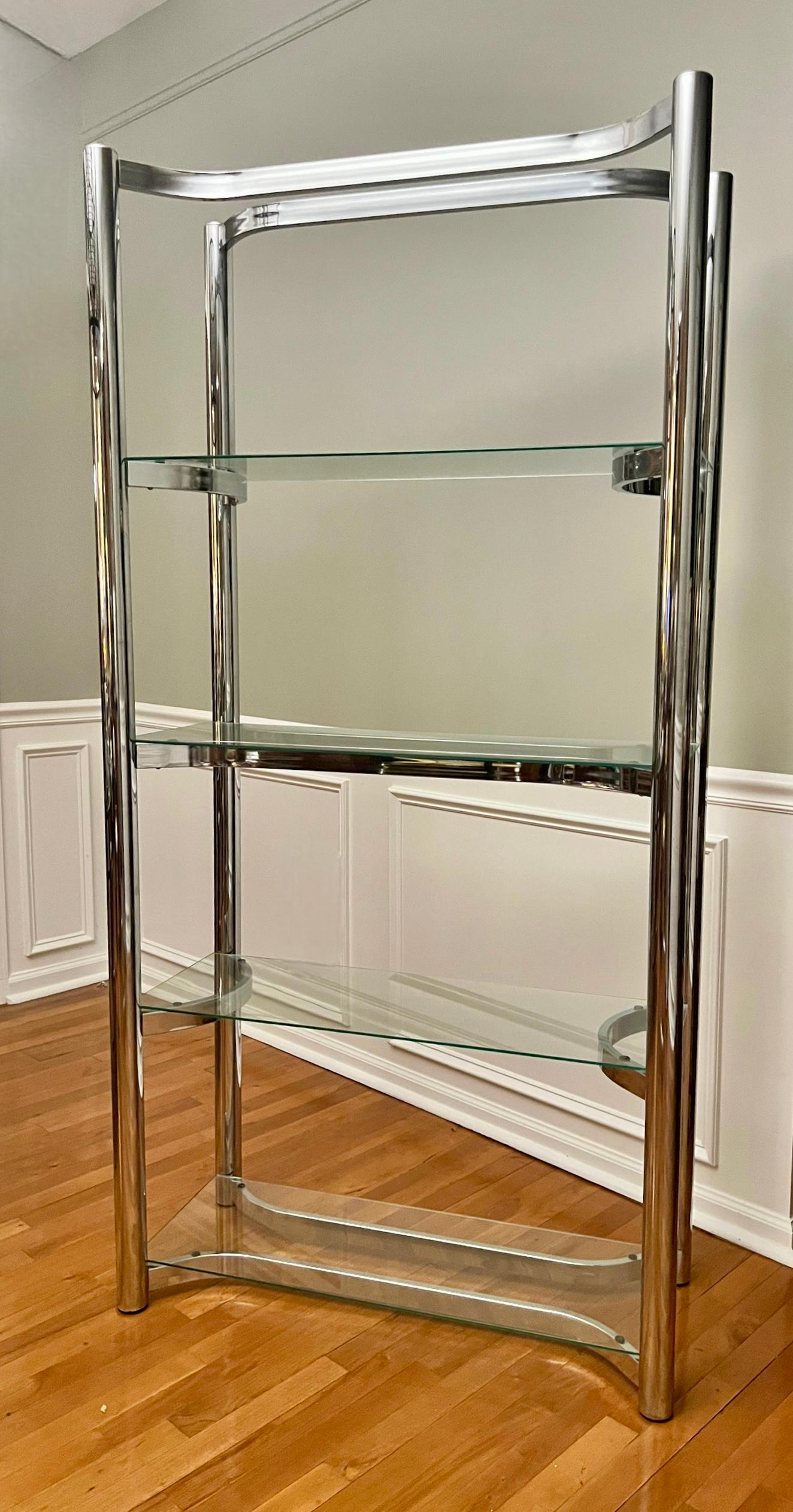 1970s chrome etagere with four glass shelves attributed to Milo Baughman.

Chrome plated steel frame with flat bar shelf supports set in an alternating curved pattern which add visual interest and nicely complement the thick tubular chrome