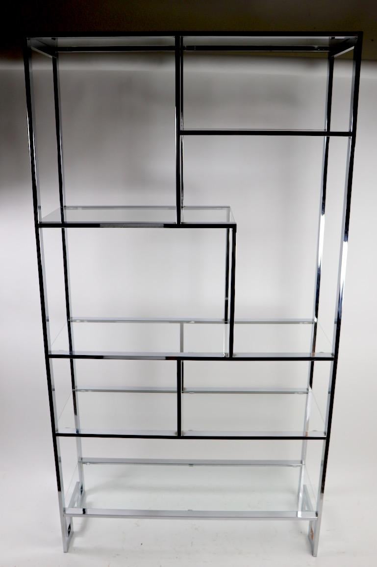 Stylish, architectural and chic chrome and glass étagère. This freestanding shelf features 6 shelves including 4 full width and 2 parcial width shelves. The chrome and glass elements are all in very good original condition, clean and ready to