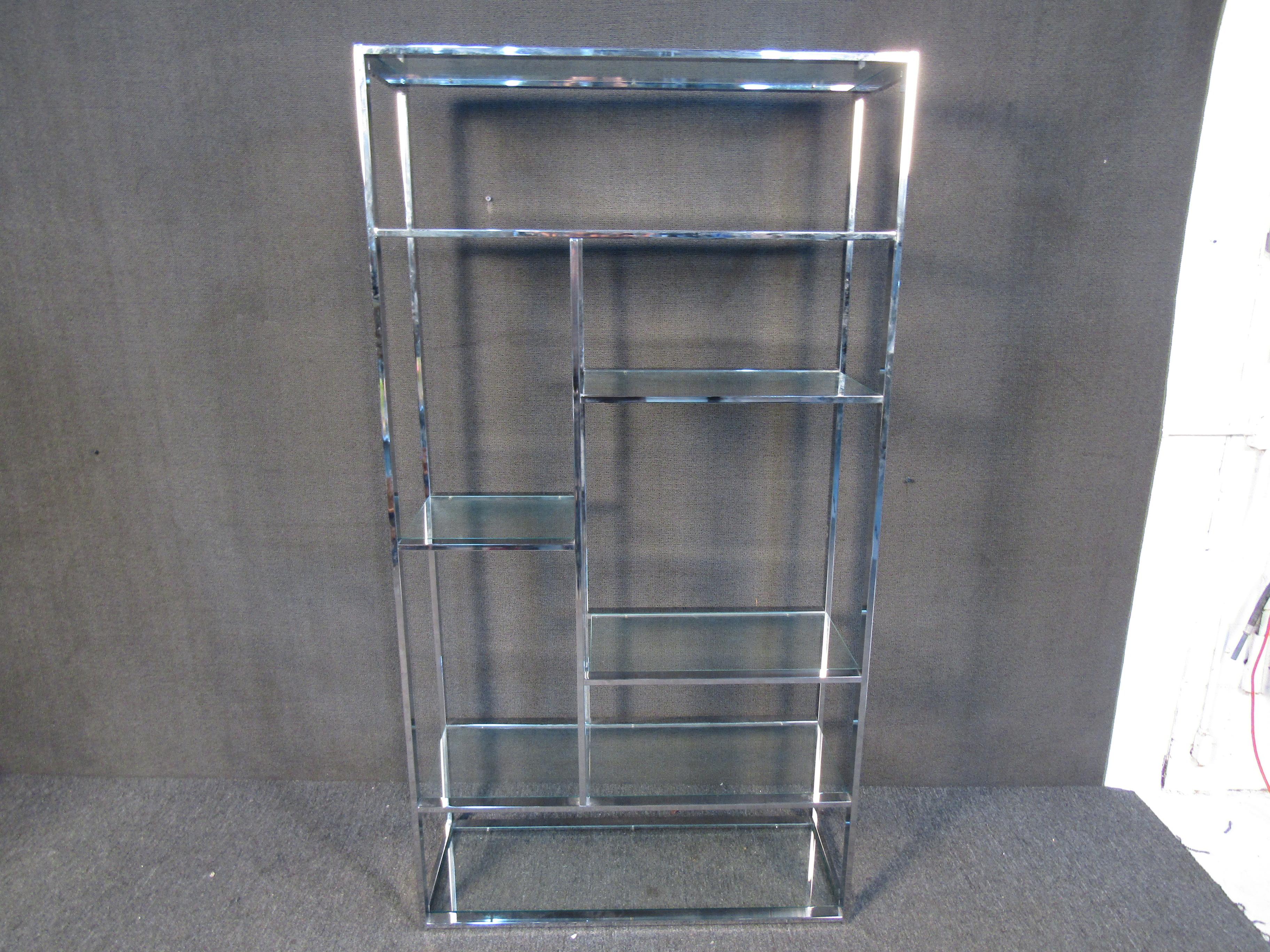 An elegant and minimal etagere in chrome and glass. This vintage piece is crafted in the style of the designer Milo Baughman. Please confirm item location with seller (NY/NJ).