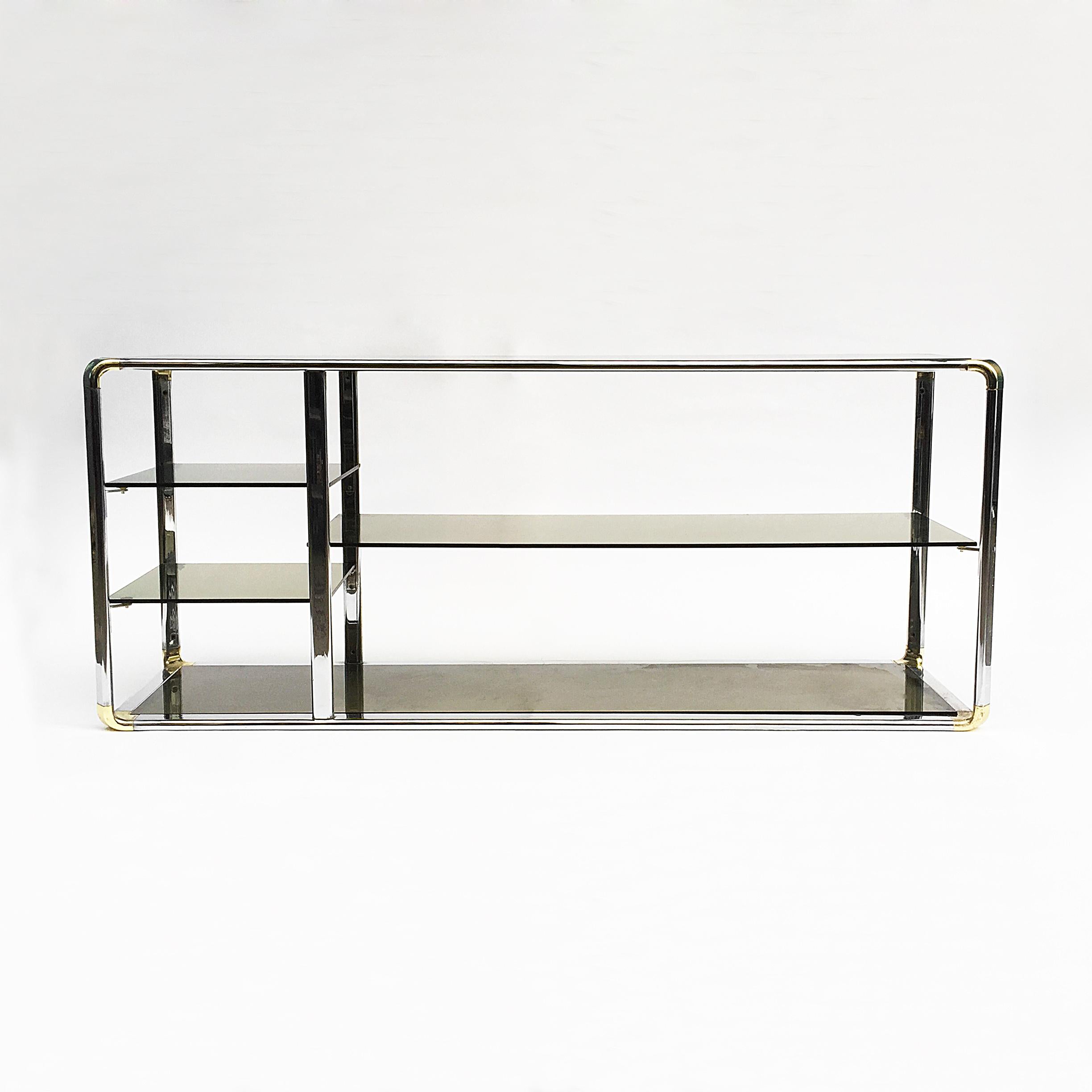 A chrome sound system display unit with smoked glass shelves. Chrome curved edges with brass plated corner details. Very practical and modern piece.