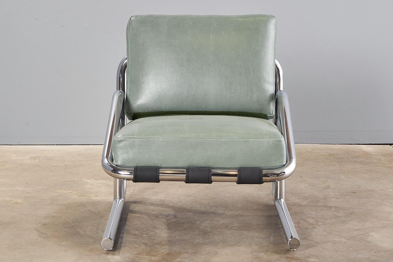 A unique chrome sling chair with leather box cushions. Very sturdy construction; the light aqua green leather is relatively new and shows some wear as expected but nothing major of note. Comfortable with just the right amount of curves, this one is