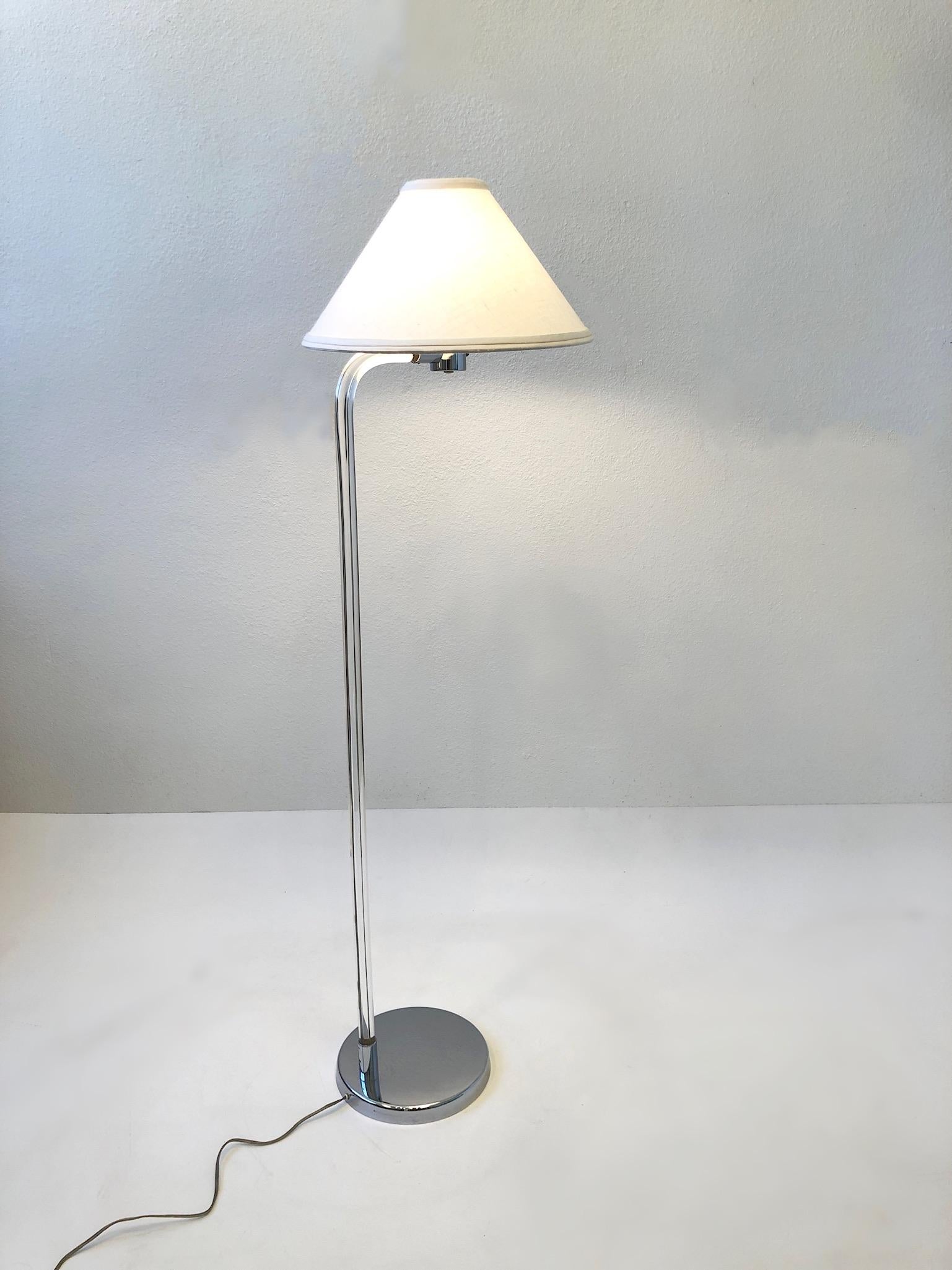 1970’s clear lucite and polish chrome with linen shade by Peter Hamburger.
In original condition with minor wear consistent with age. 
It takes a regular Edison lightbulb 75w max. 
Measurements: 17” Wide, 16” Deep, 53.5” High, 44.75” High to