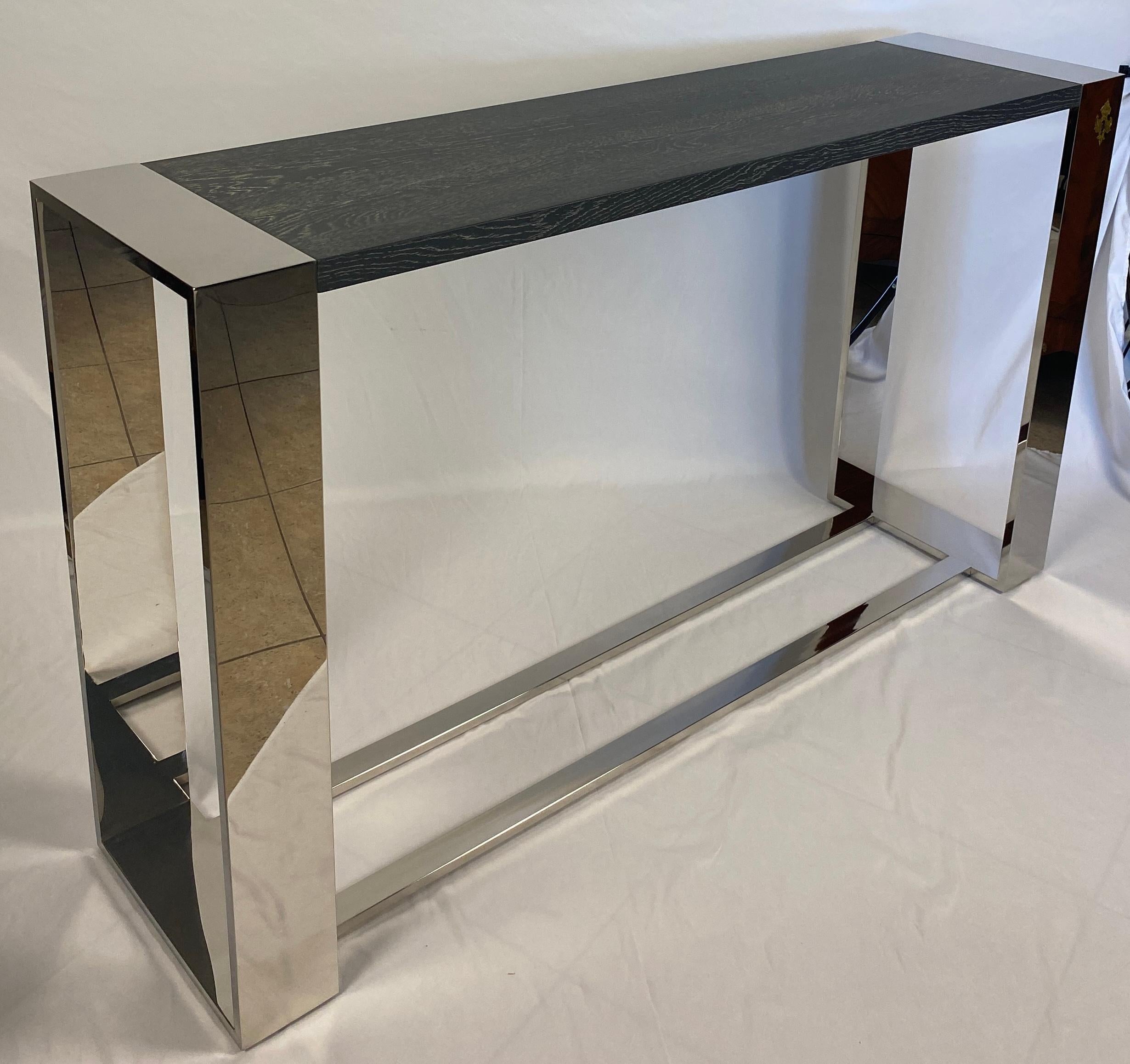 A good quality chrome and wood top console table or sofa table. 
The wood top is finished in a light gray painted adding details to the chrome base. All wood is kiln-dried for durability. 

Chrome legs and base for a more versatile look that would