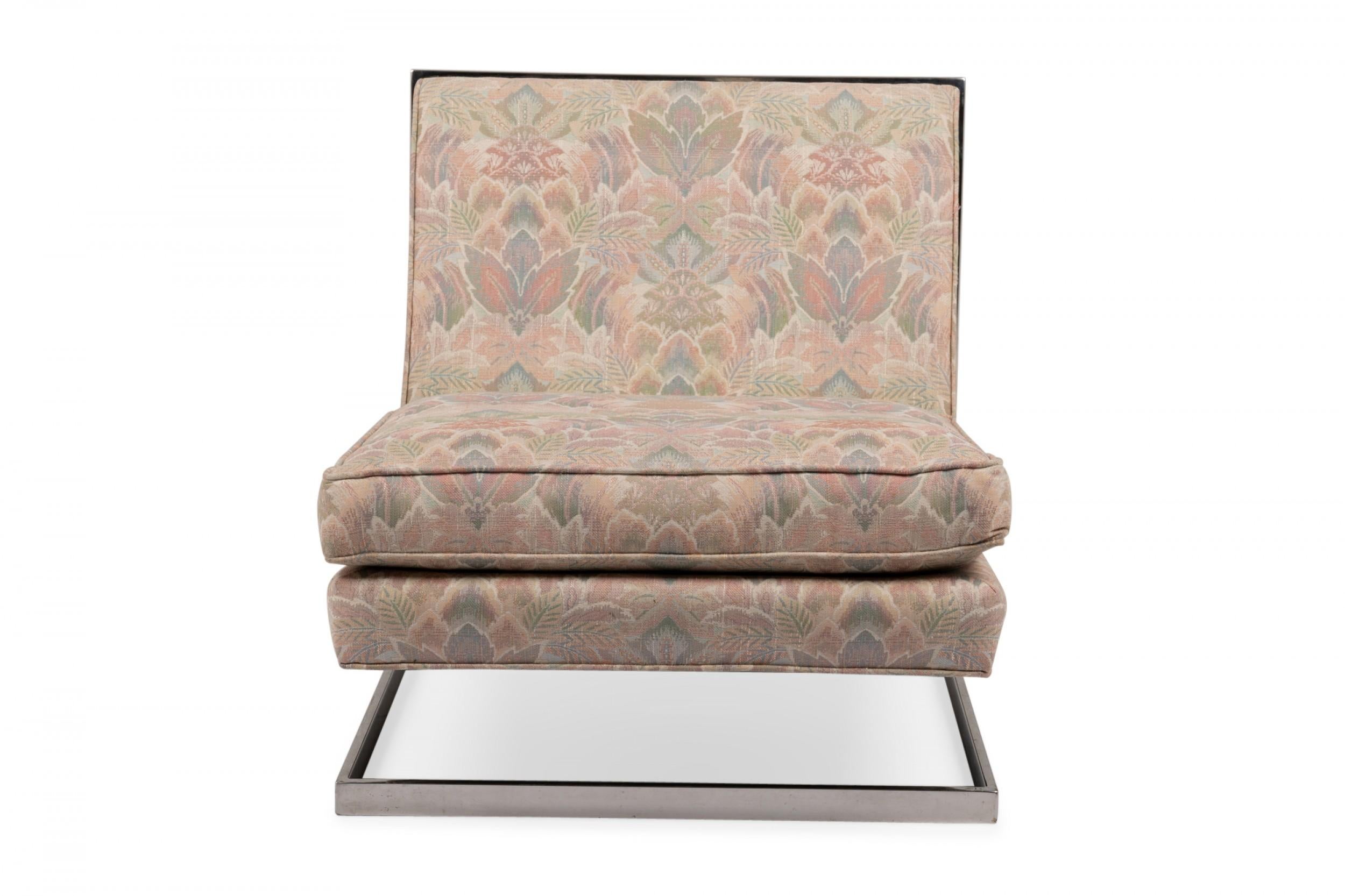 American Mid-Century floating slipper chair with pink, green, and beige floral fabric upholstery with a removable seat cushion, supported by a square chrome tube frame. (manner of MILO BAUGHMAN).
 